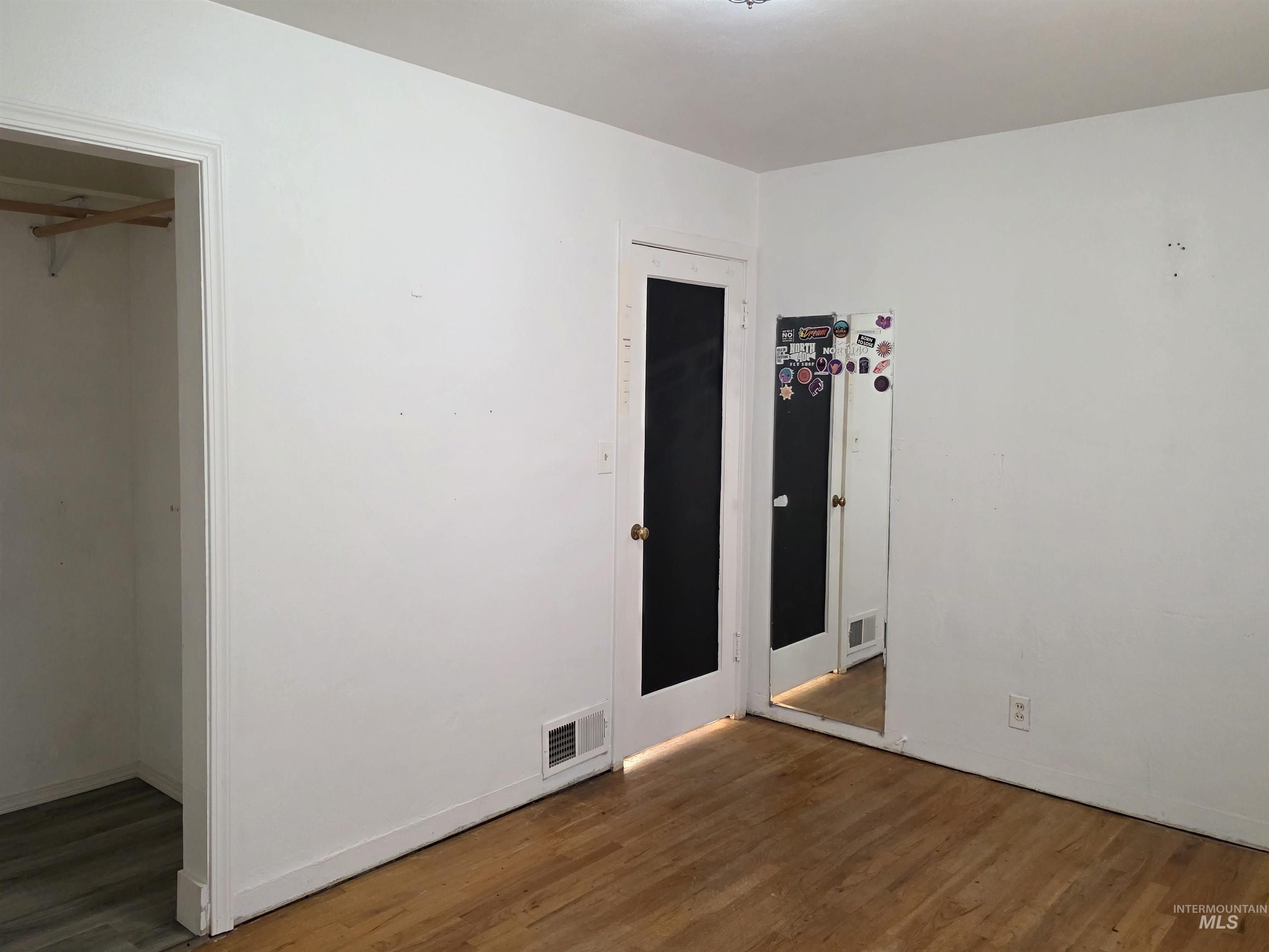 Unfurnished bedroom with dark wood finished floors