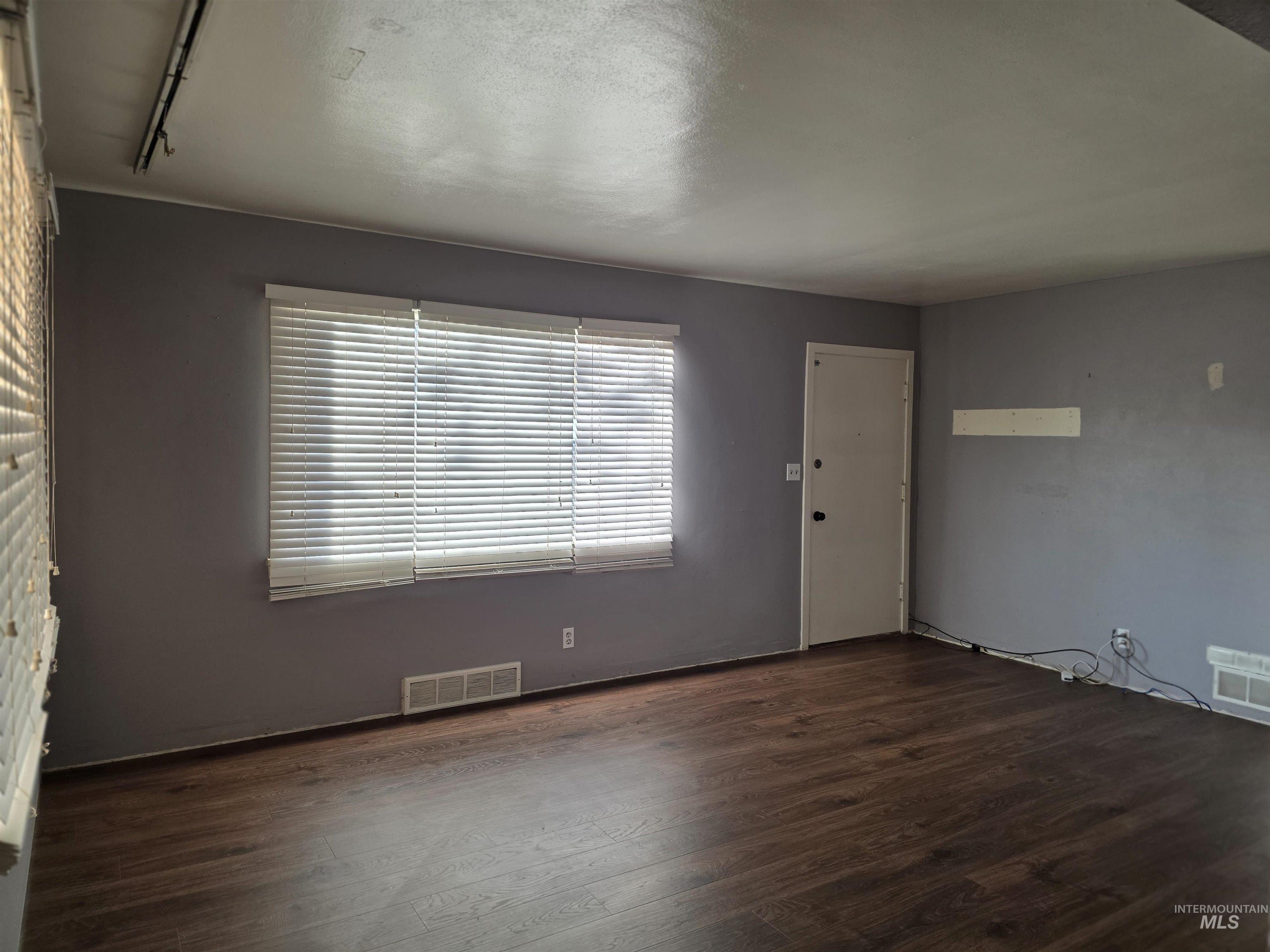 Entrance foyer with dark wood-type flooring and rail lighting