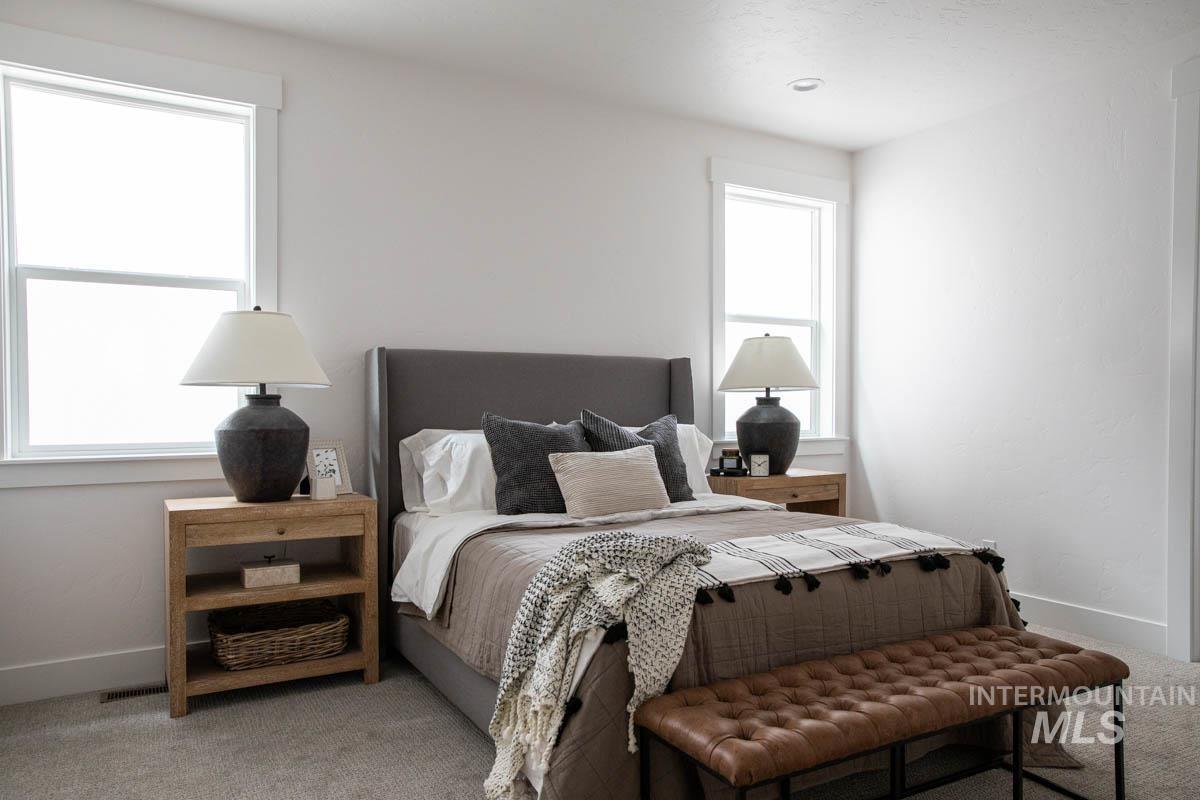 Carpeted bedroom featuring baseboards