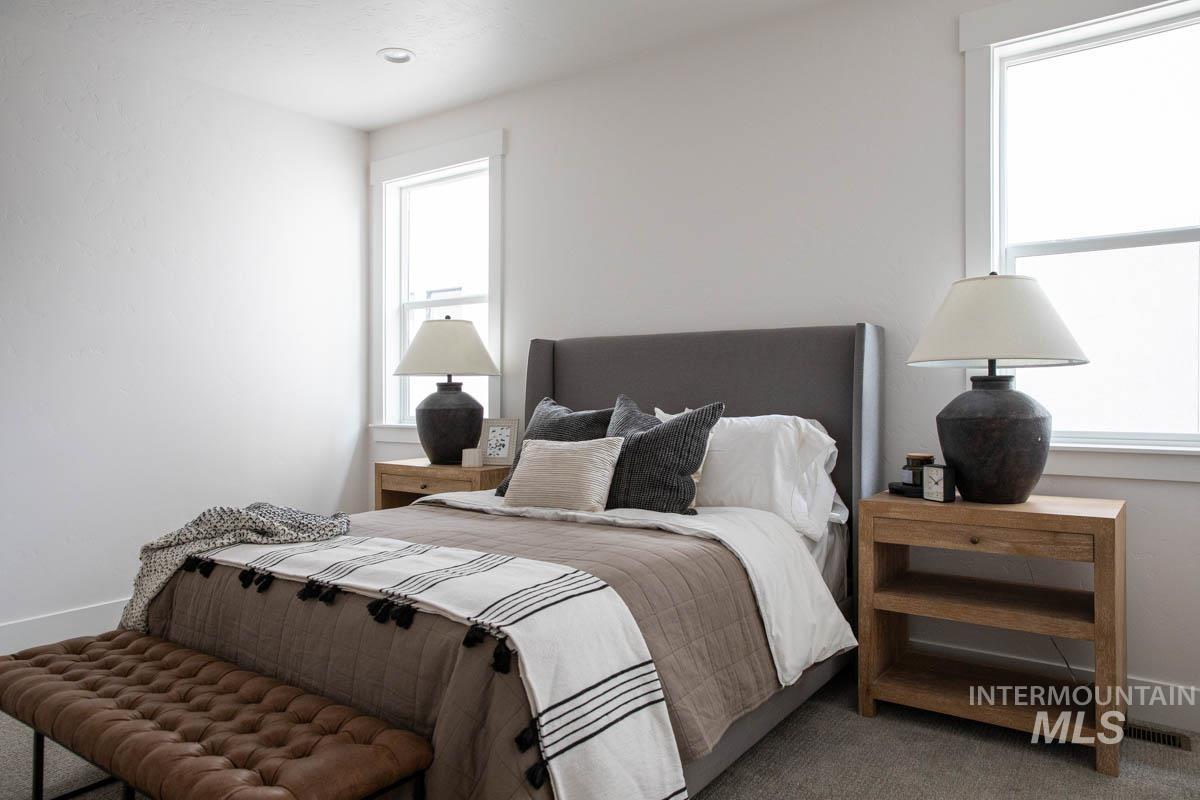 Bedroom with baseboards and carpet
