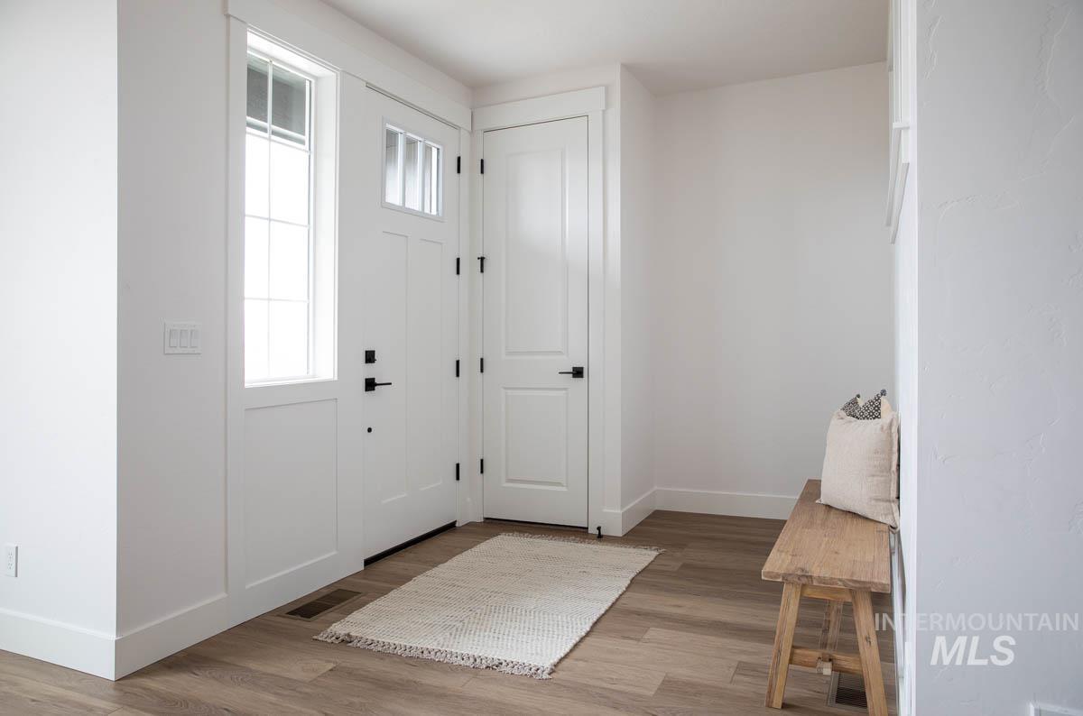 Entryway featuring baseboards and light wood-style flooring