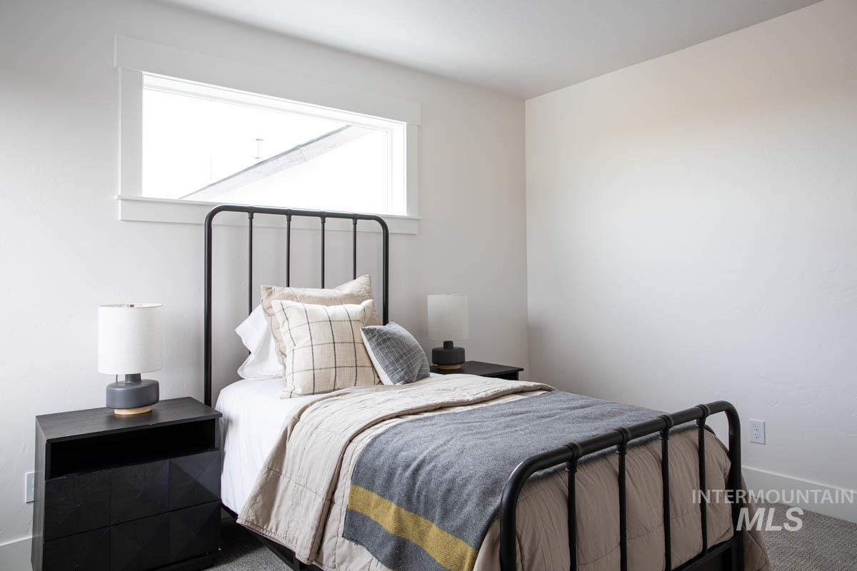 Carpeted bedroom featuring baseboards