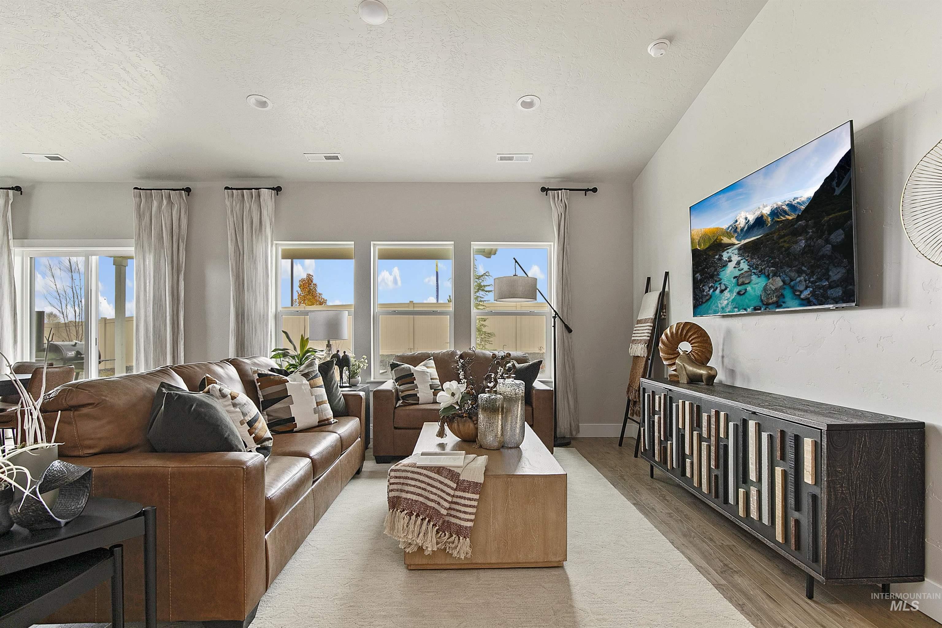 Living area with wood finished floors and a textured ceiling