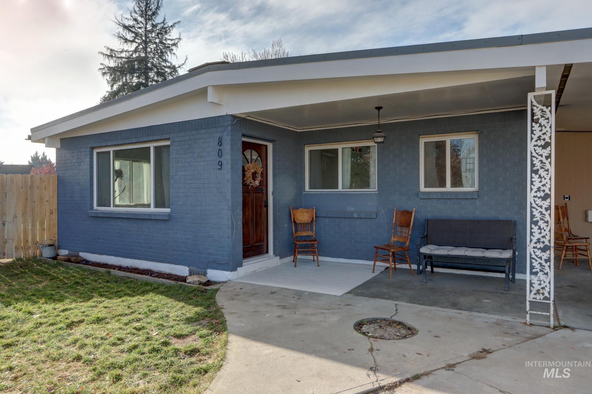 Rear view of property with brick siding and a patio area