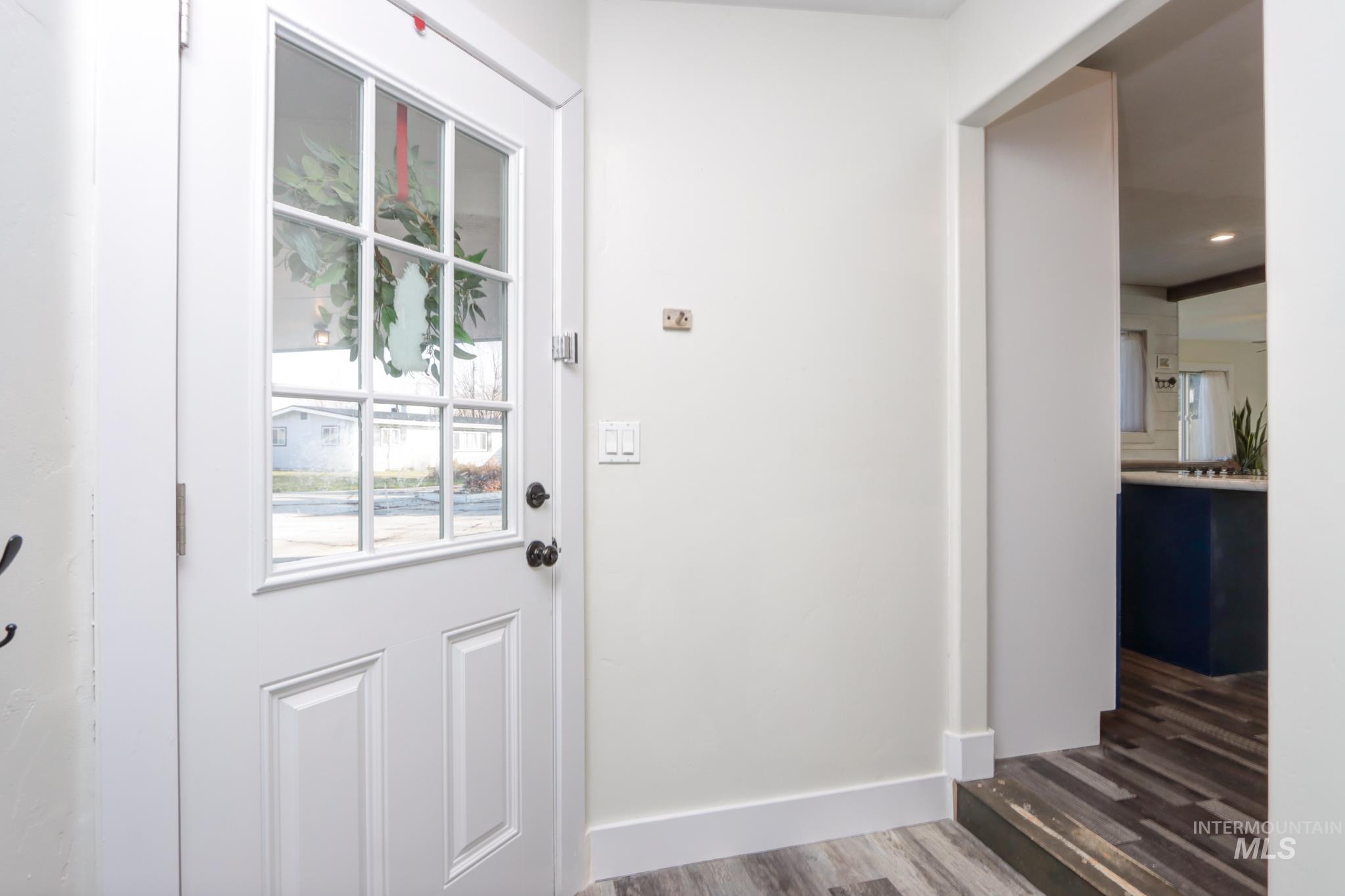 Doorway featuring wood finished floors