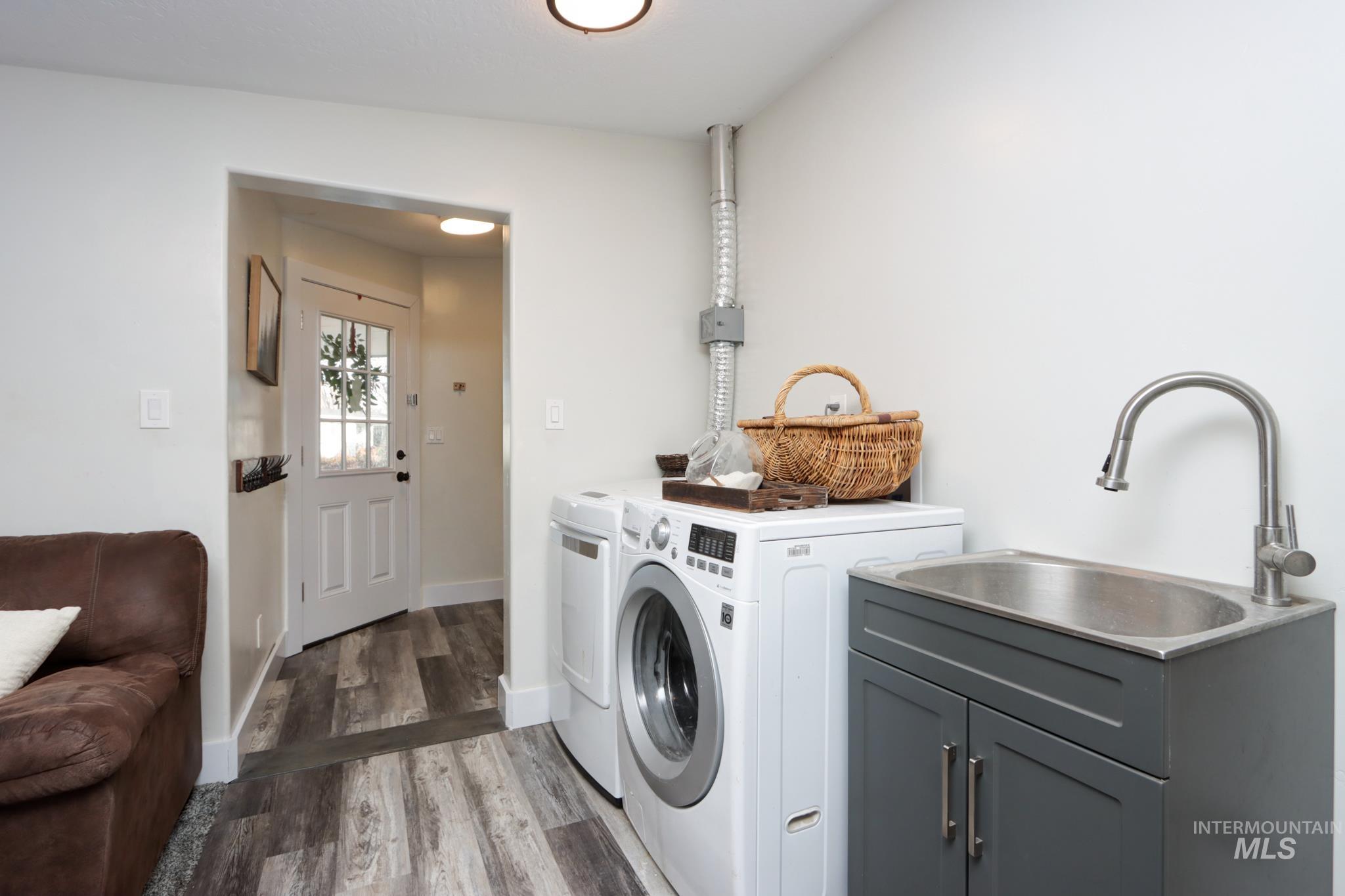 Laundry area featuring separate washer and dryer and light wood-style floors