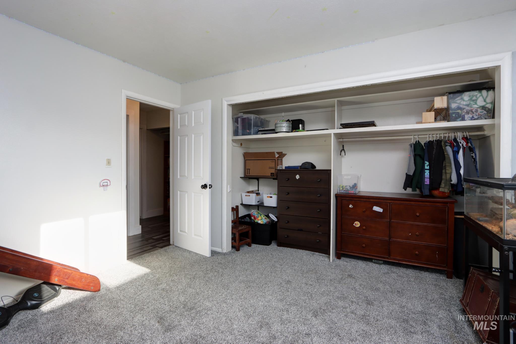 Bedroom with a closet and light carpet