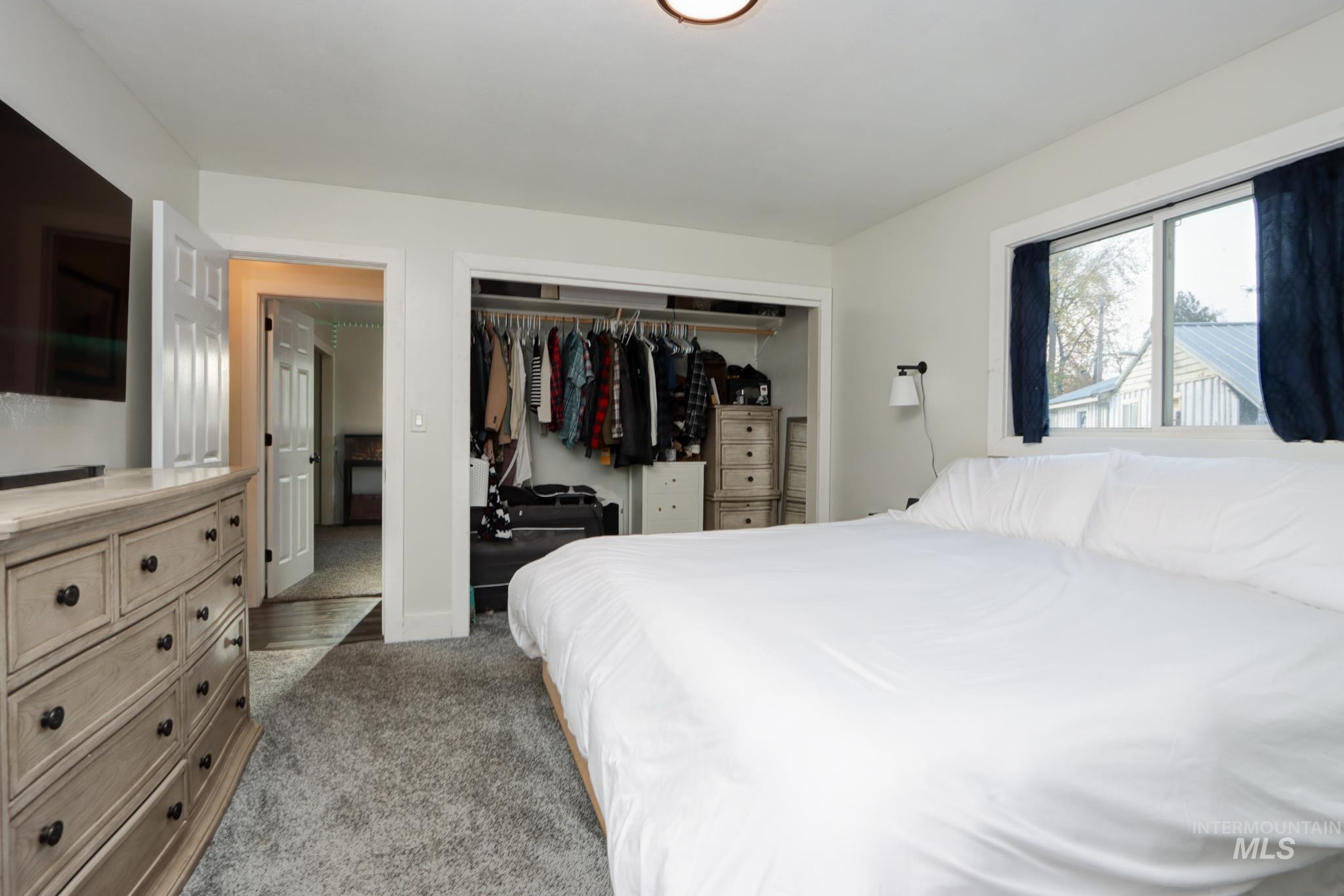 Bedroom featuring light colored carpet and a closet