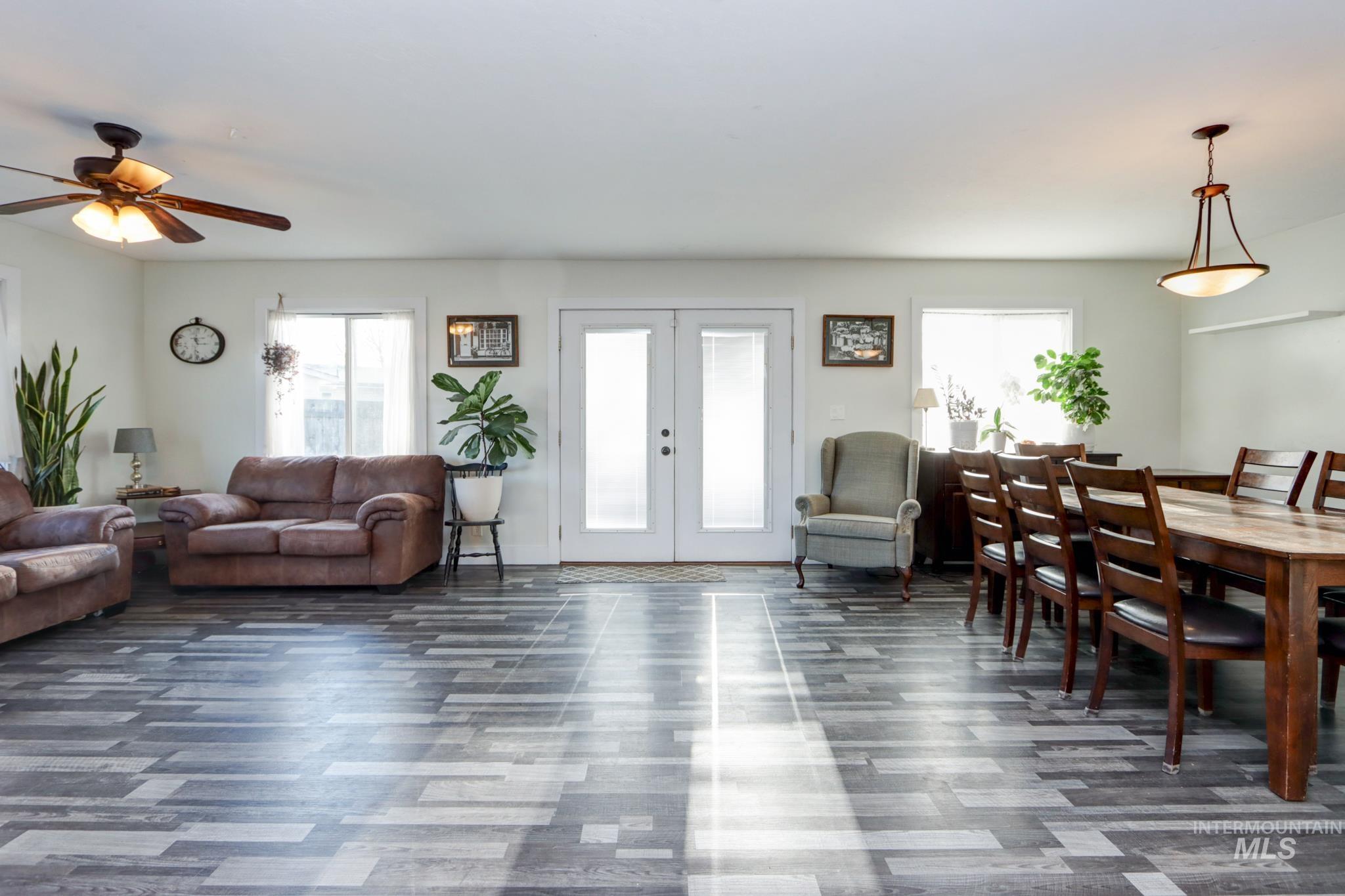Living room featuring french doors and ceiling fan