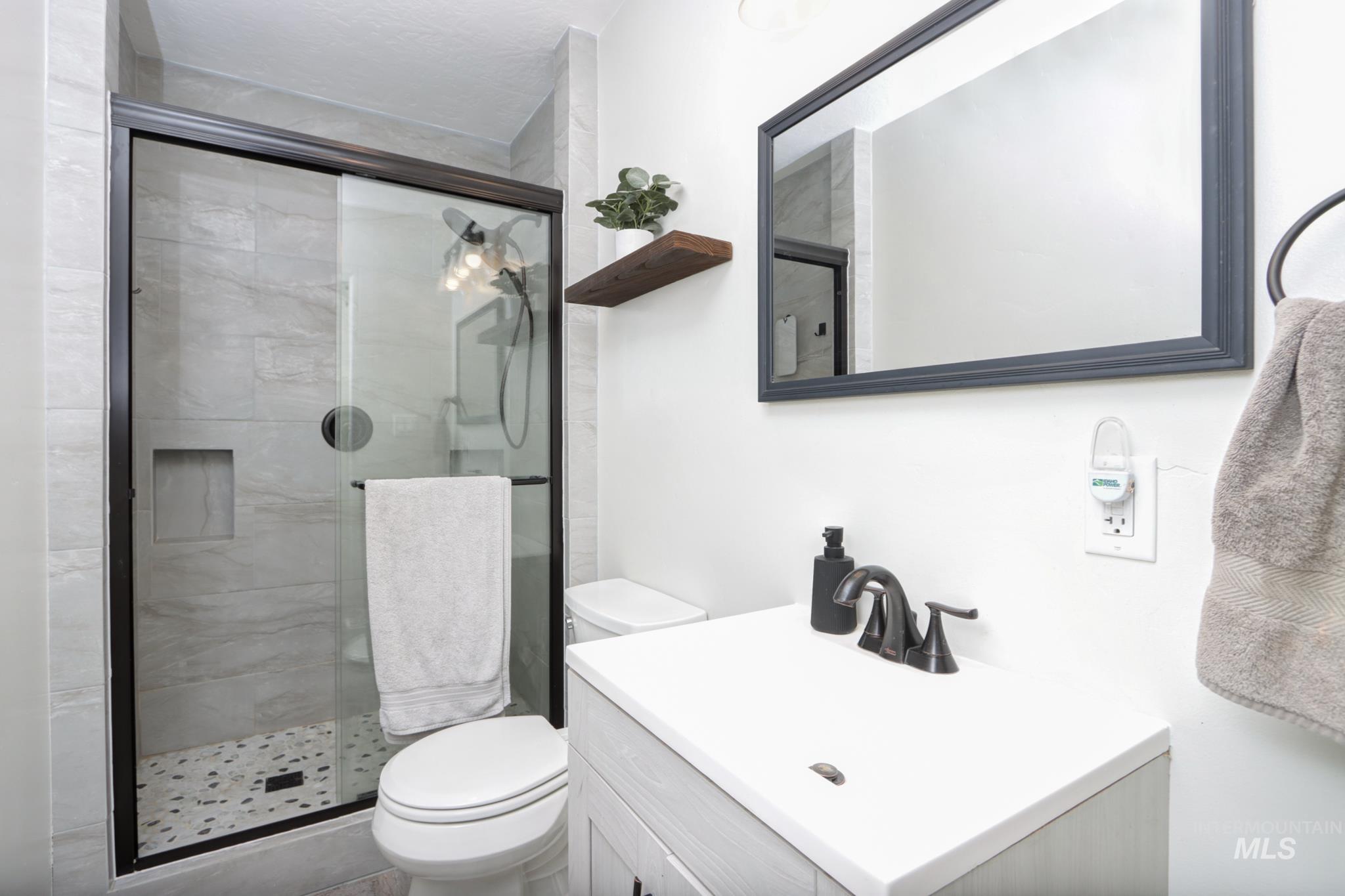 Bathroom with a stall shower and vanity