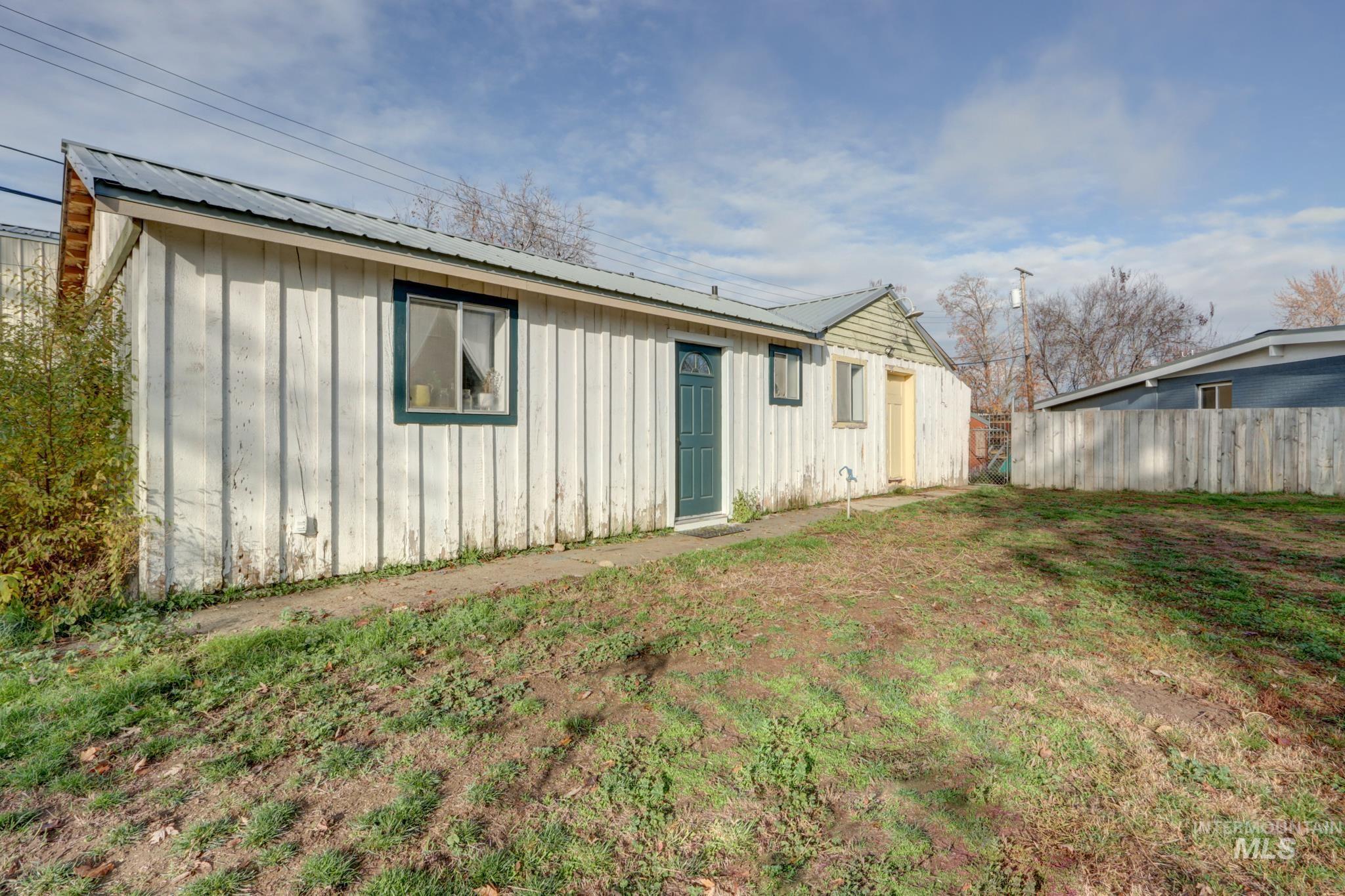 Back of house featuring board and batten siding and a metal roof
