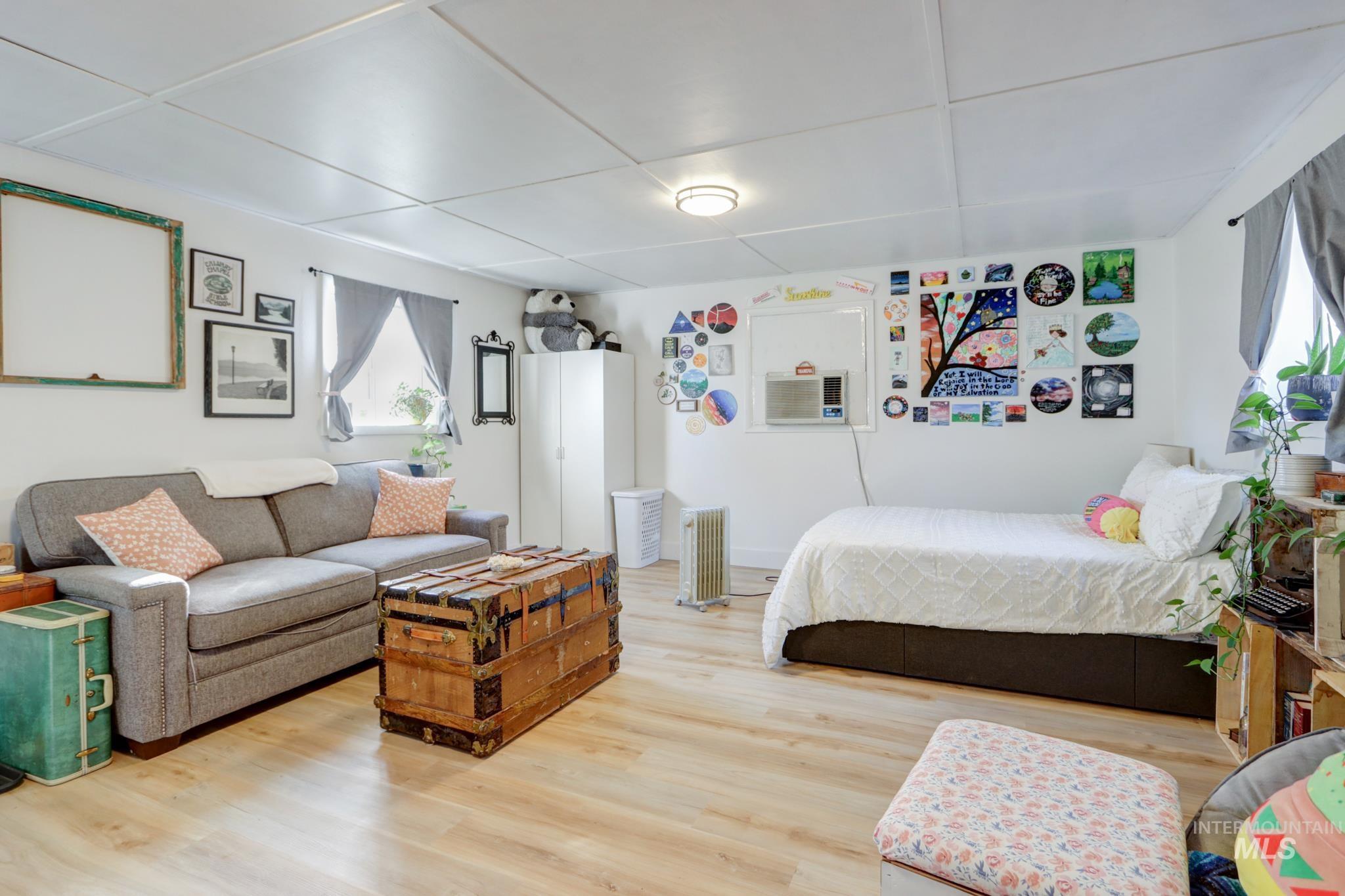 Bedroom featuring radiator heating unit and light wood-style flooring
