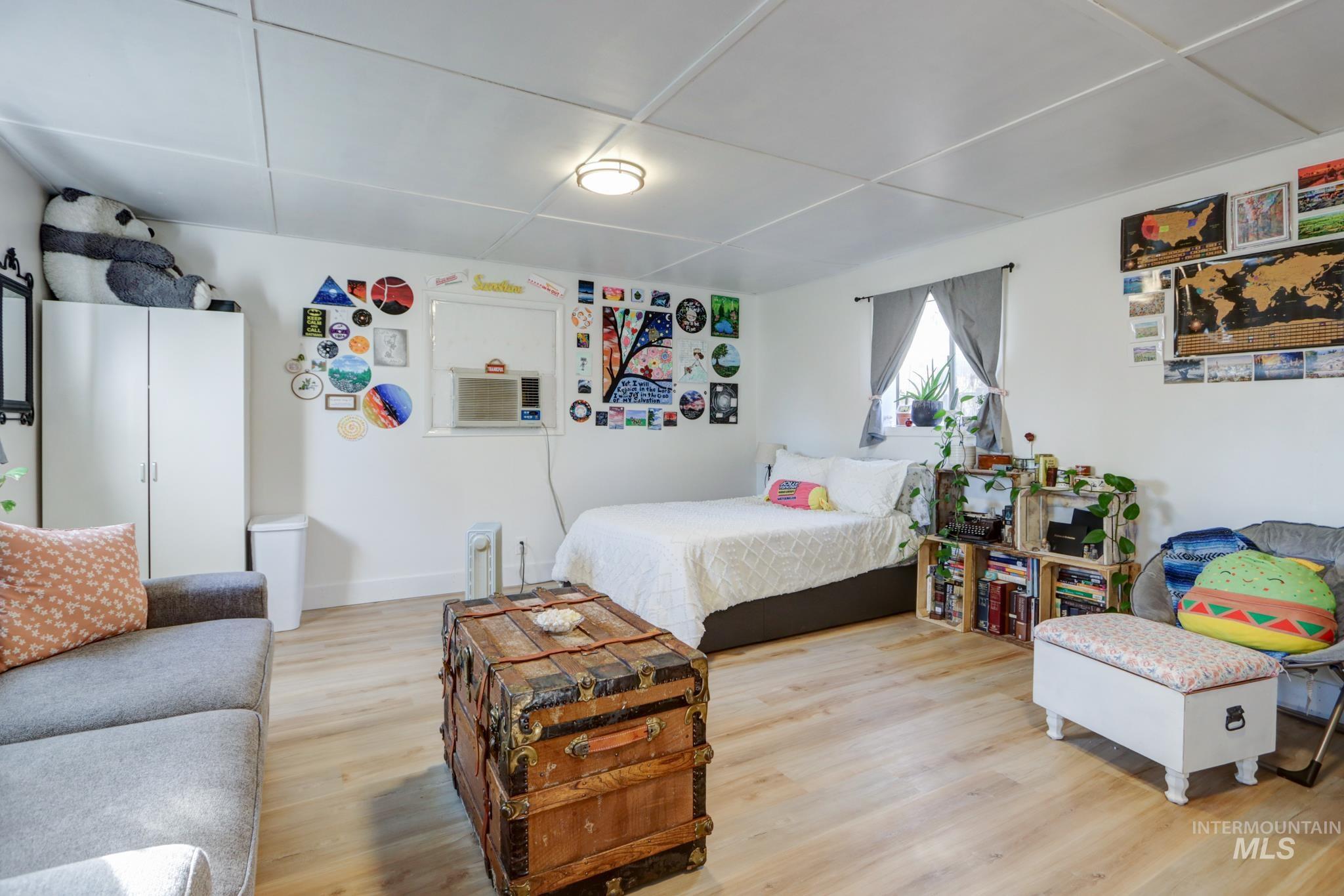 Bedroom with light wood-style floors and baseboards