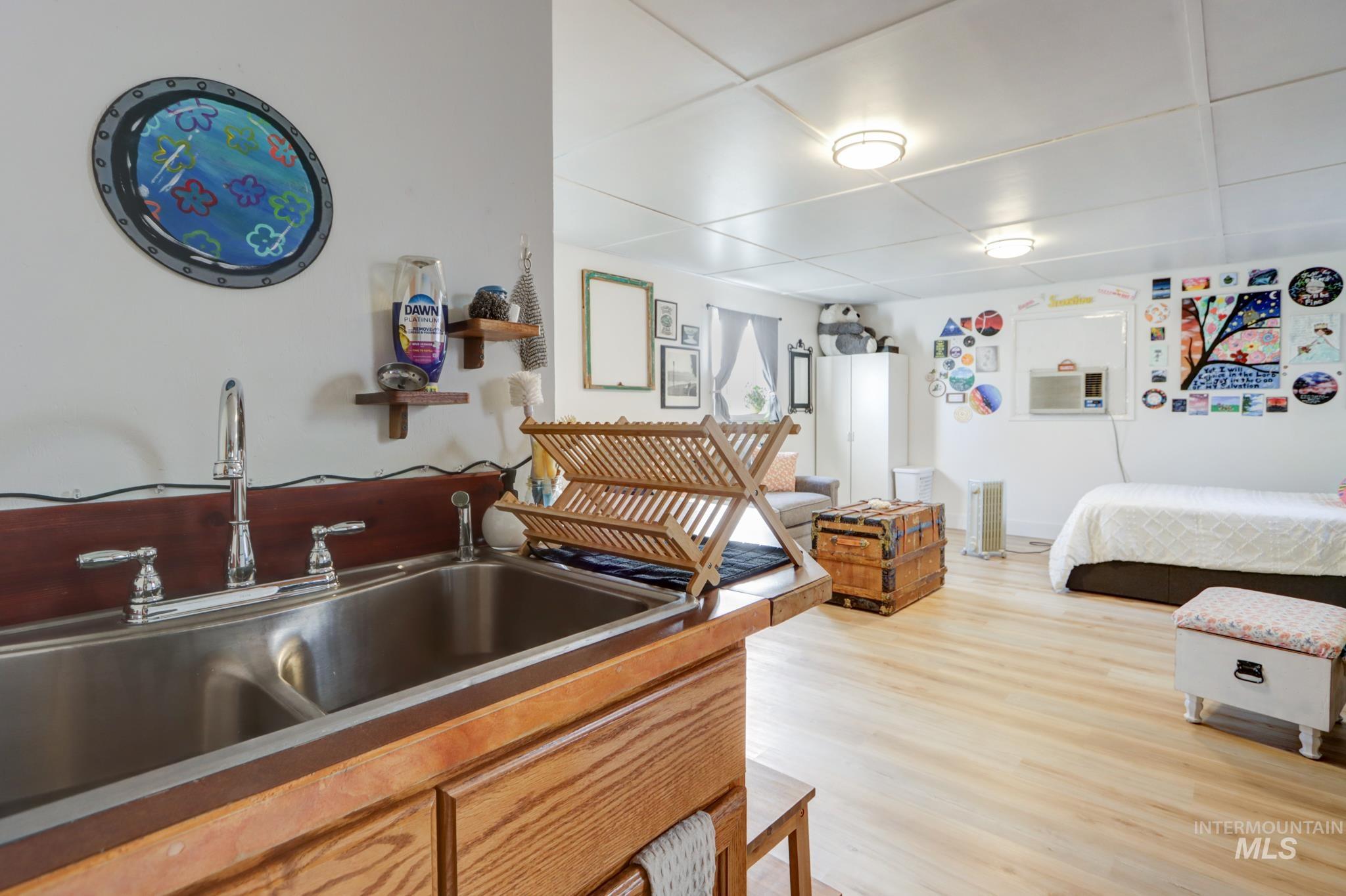 Bedroom featuring a sink and light wood-style floors