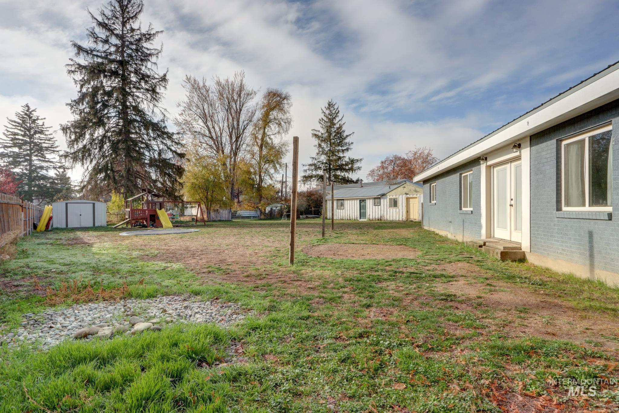 View of yard featuring a playground, a shed, and entry steps