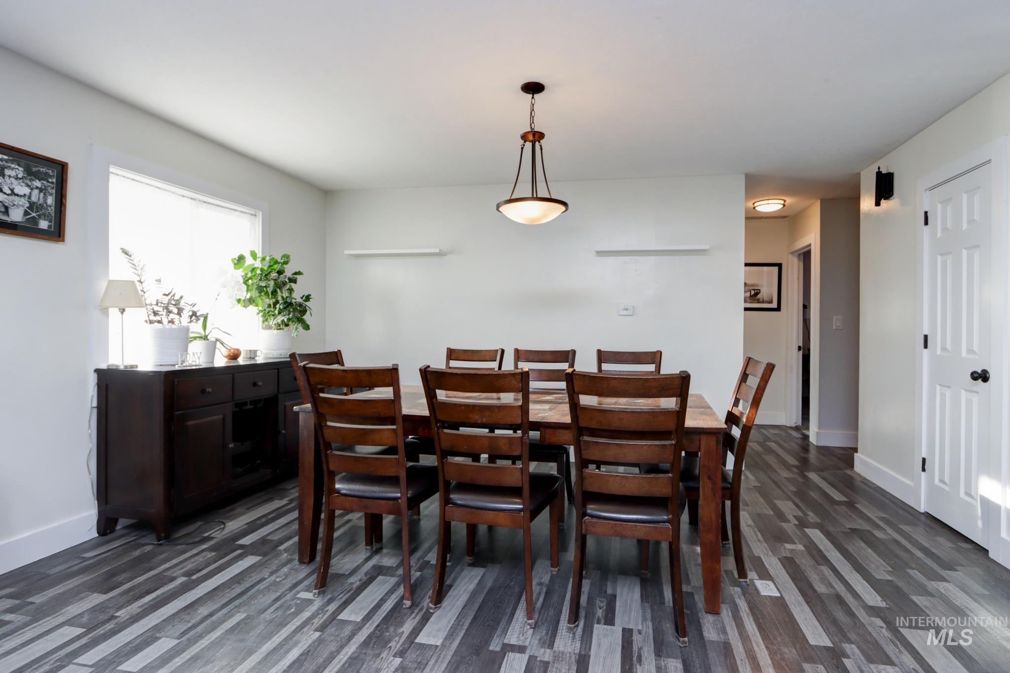 Dining area with dark wood-type flooring