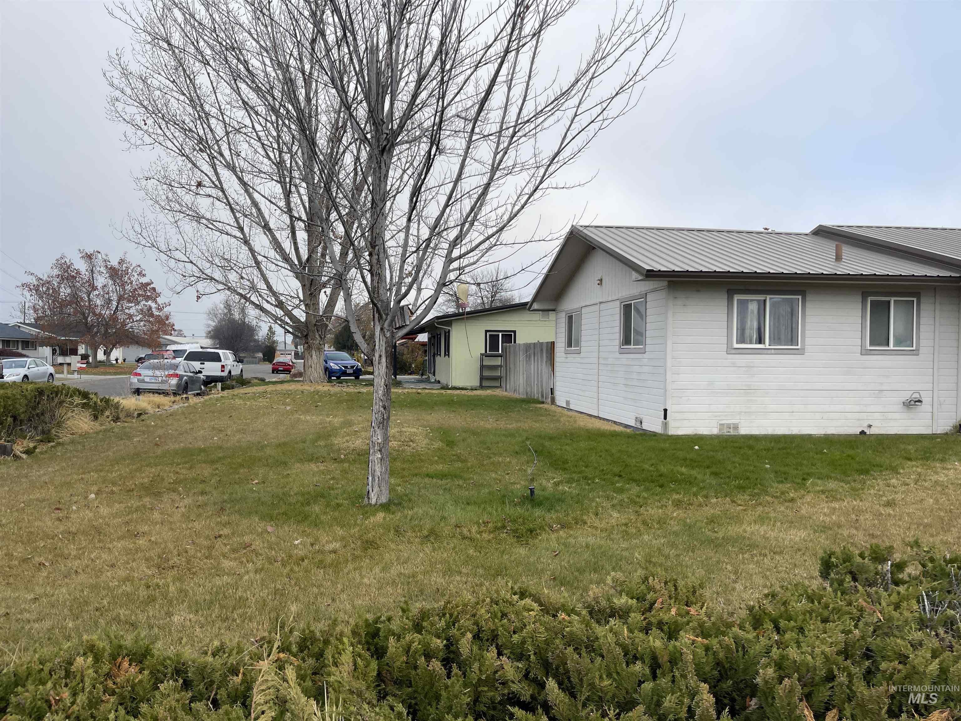 View of home's exterior featuring a yard, a metal roof, and crawl space