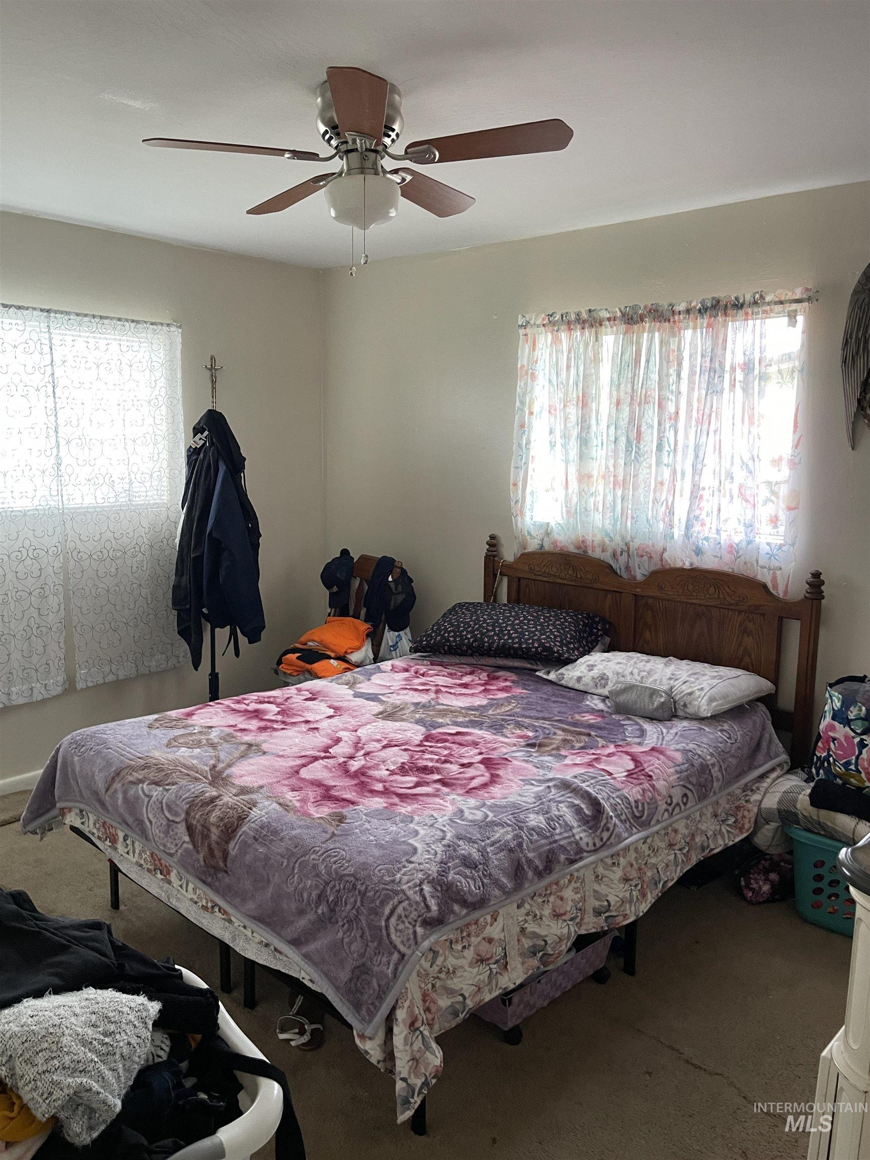 Bedroom featuring ceiling fan and carpet flooring