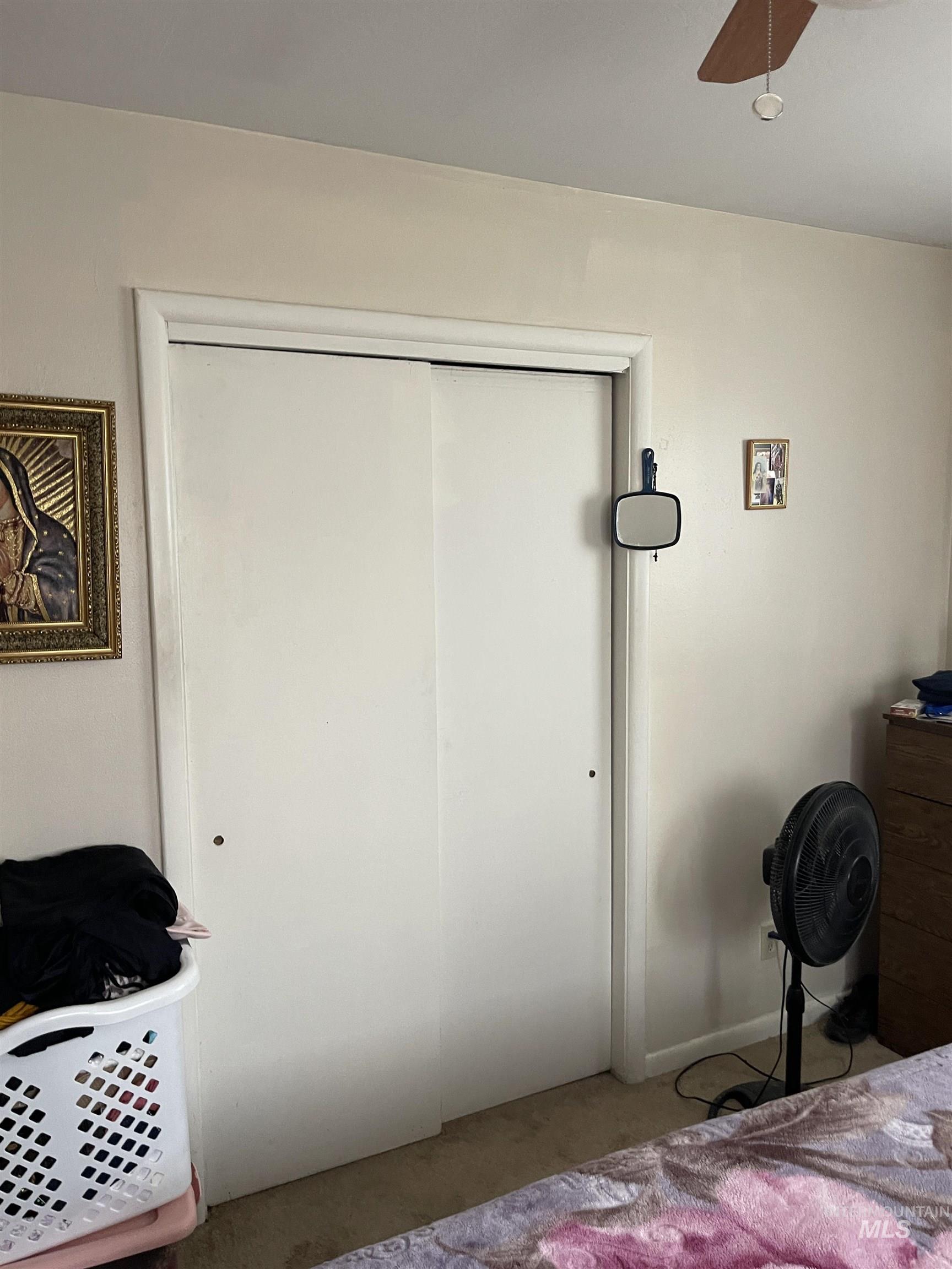 Carpeted bedroom featuring a closet