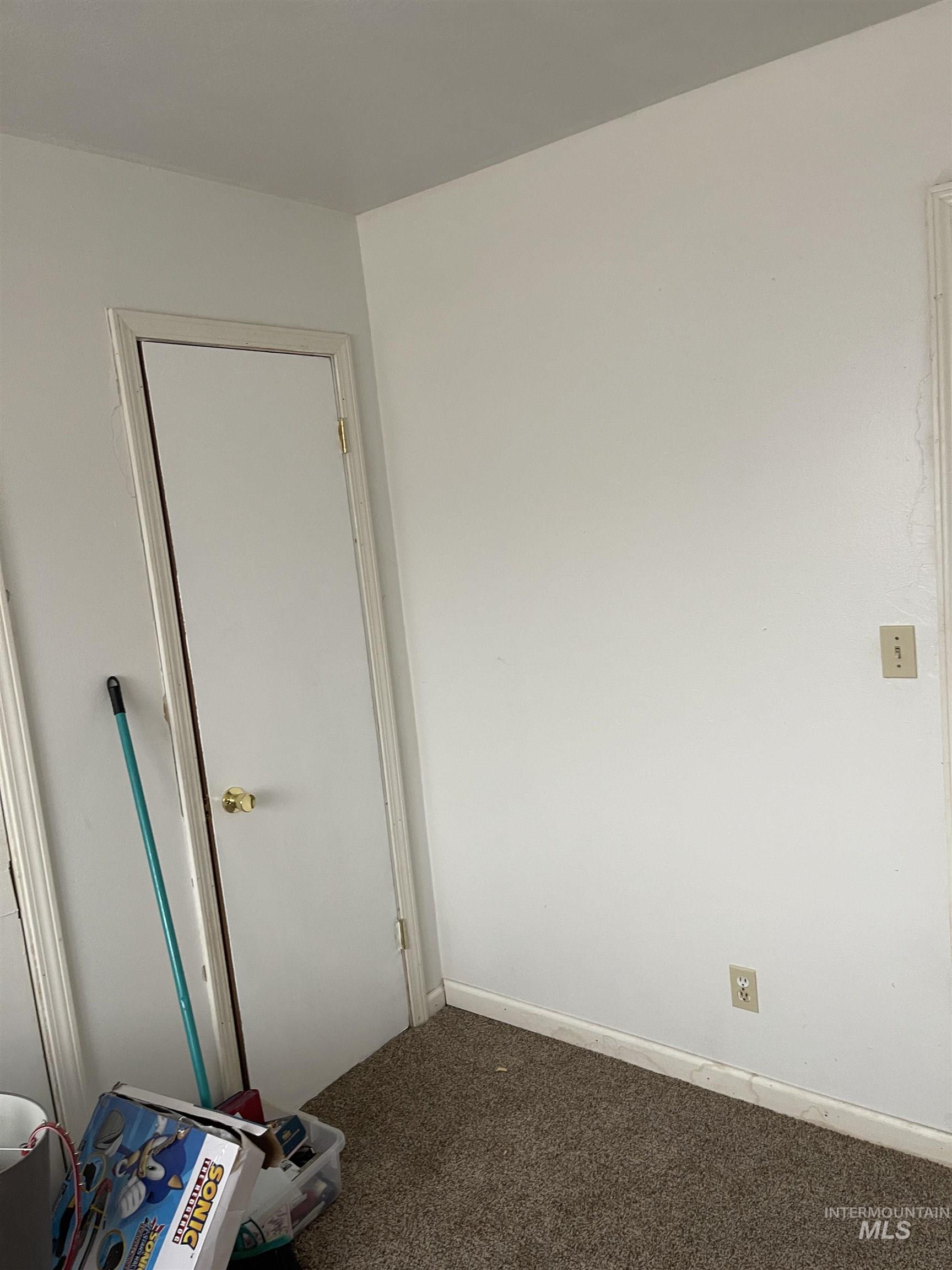 Empty room with carpet and baseboards