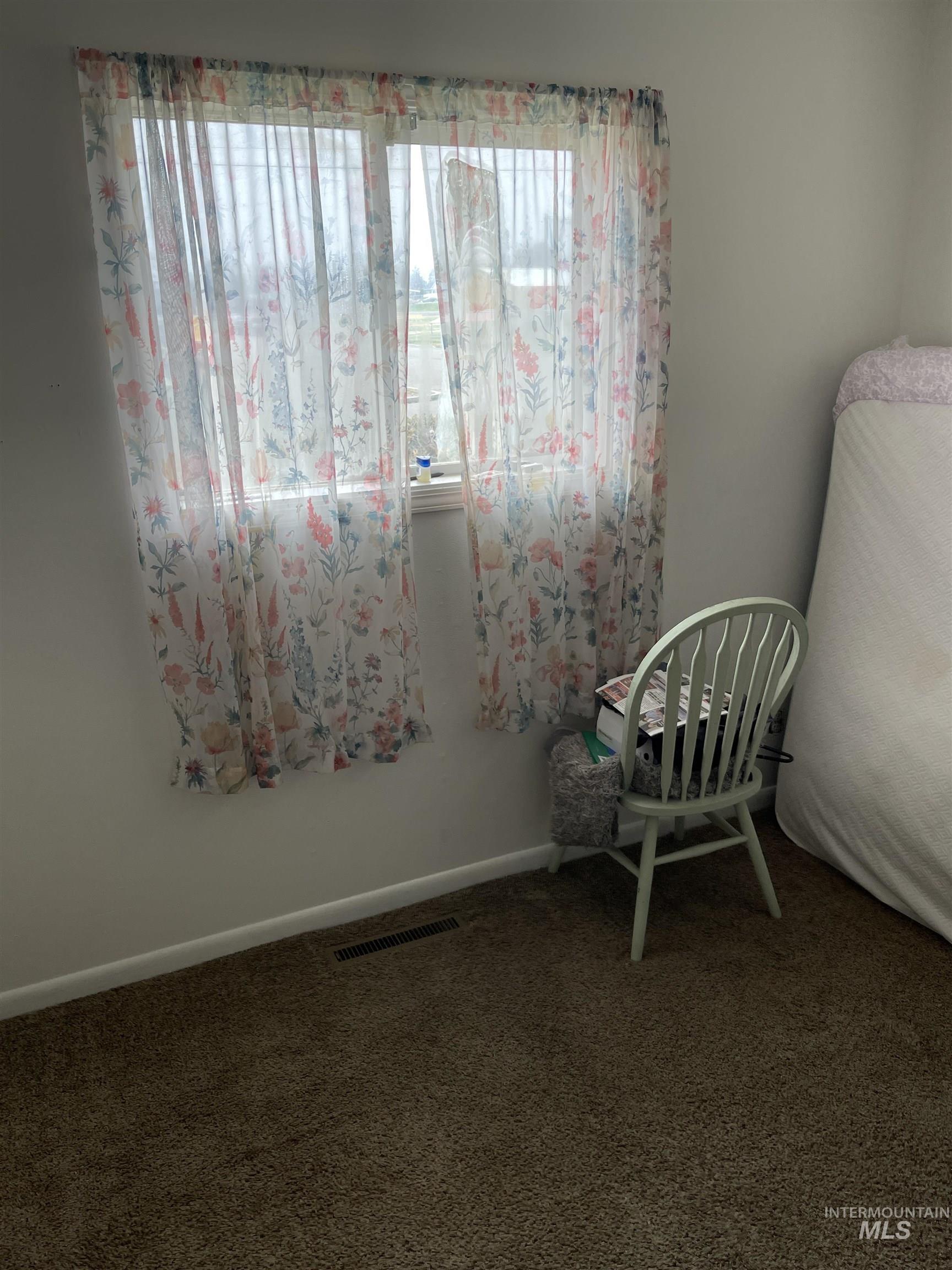 Living area with carpet and baseboards