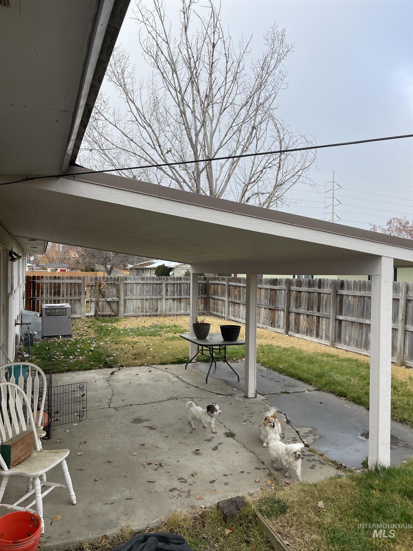 Fenced backyard featuring a patio