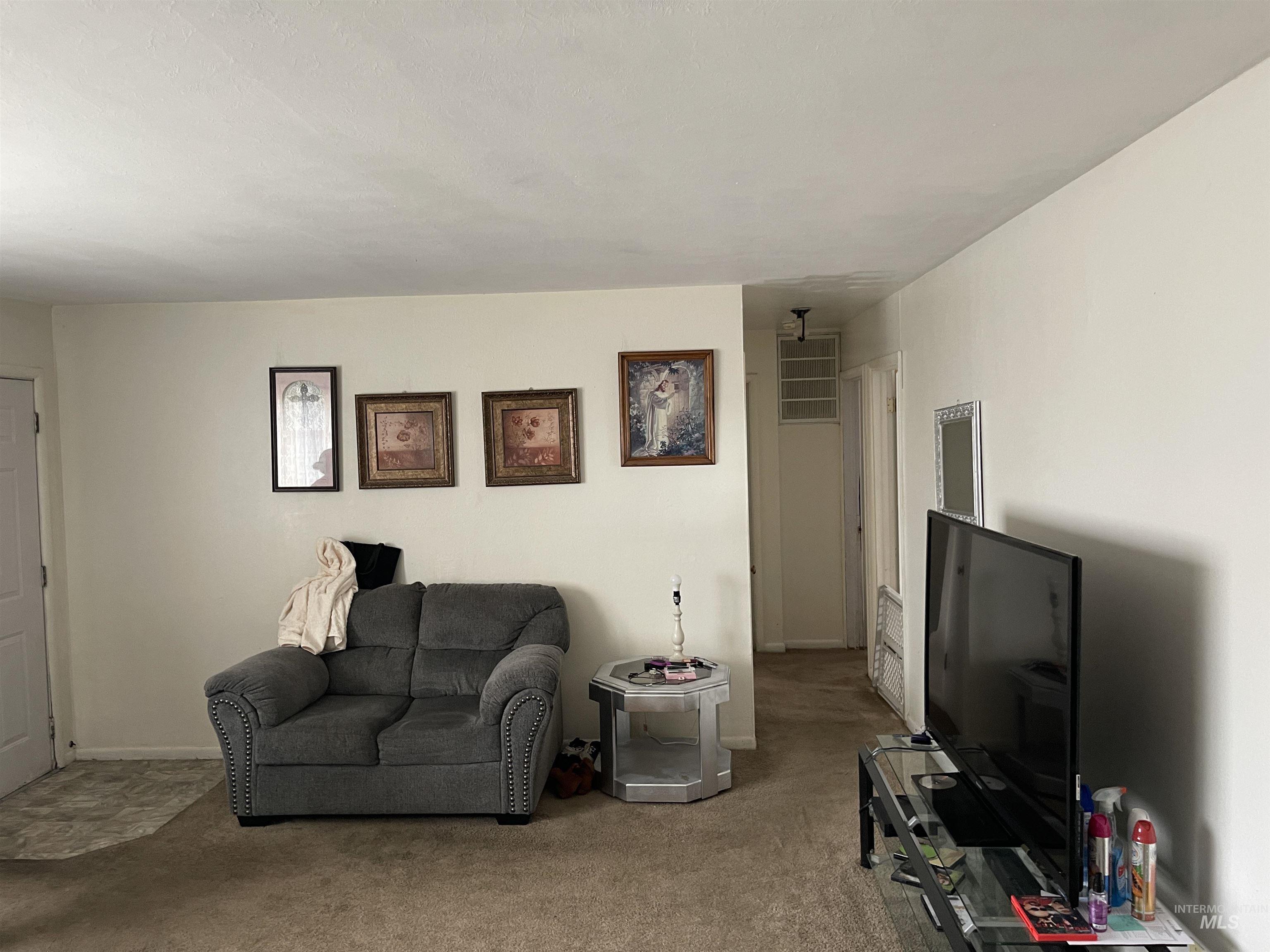 Living area with carpet and baseboards
