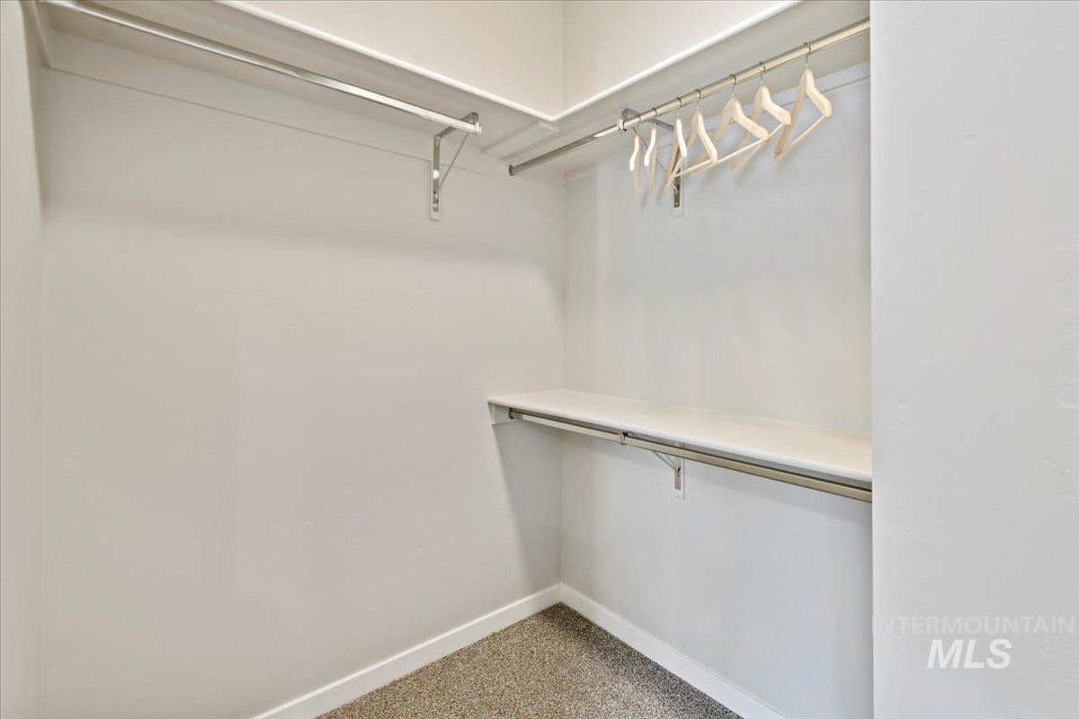 Walk in closet with light carpet