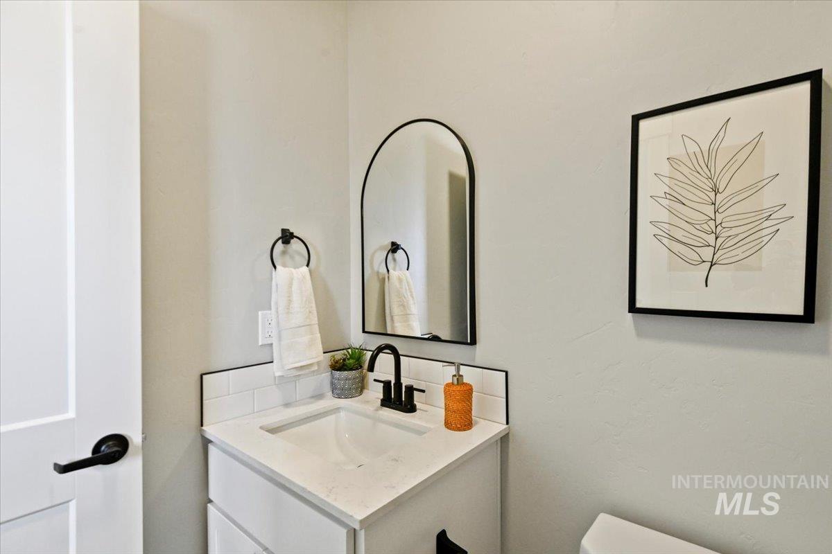 Half bath featuring vanity and toilet