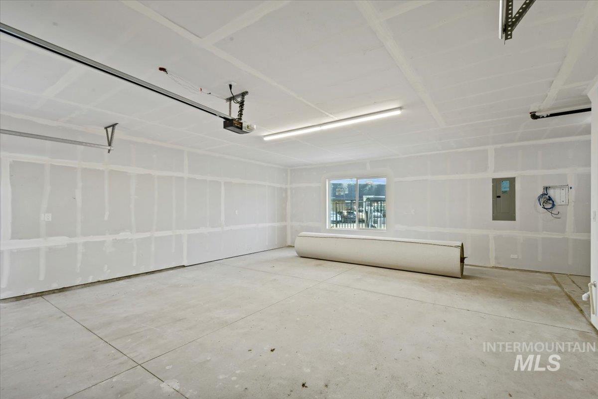 Garage with electric panel and a garage door opener