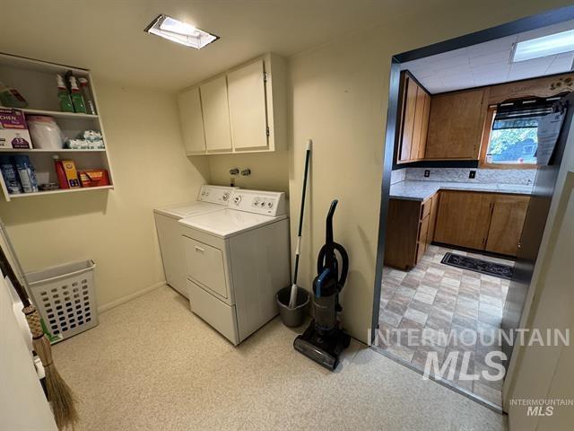 Laundry area with separate washer and dryer, cabinet space