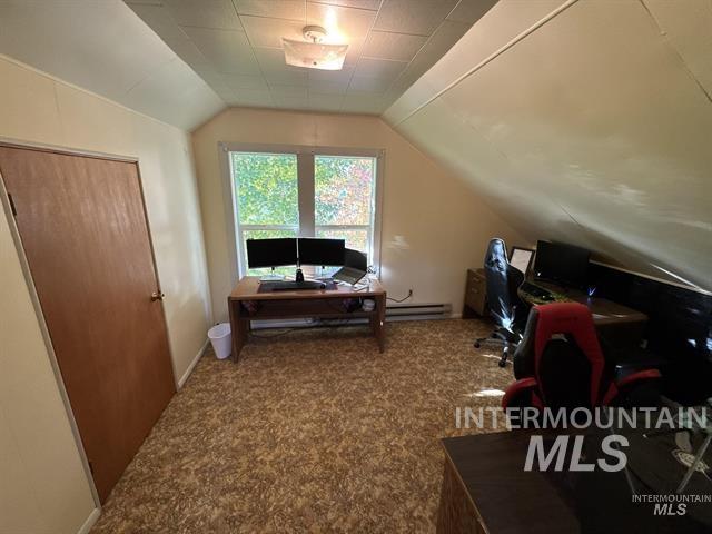 Office/bedroom featuring lofted ceiling