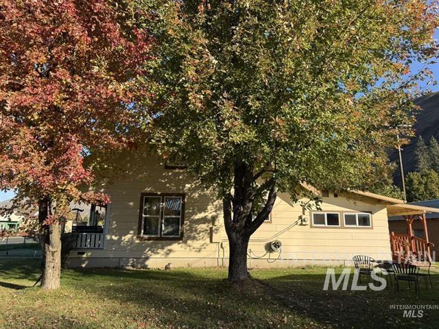 View of side of home with a lawn