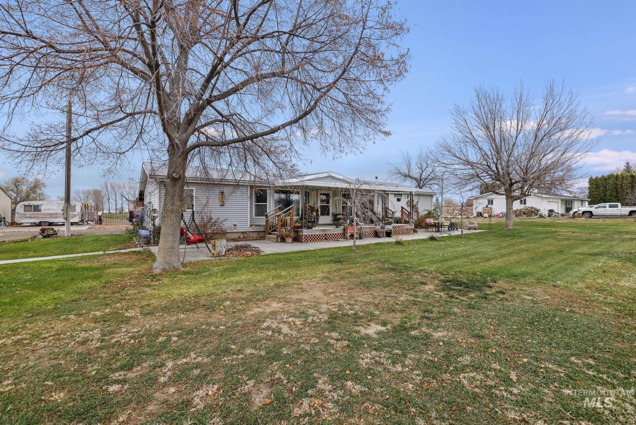 Back of home featuring a lawn and a porch