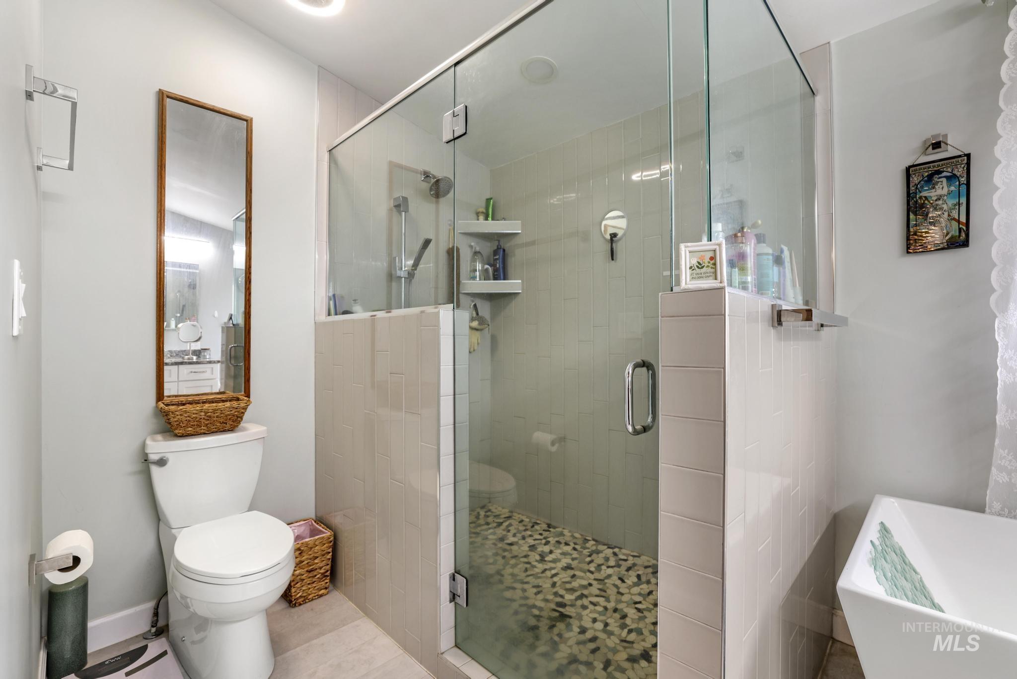 Bathroom with a stall shower and a soaking tub