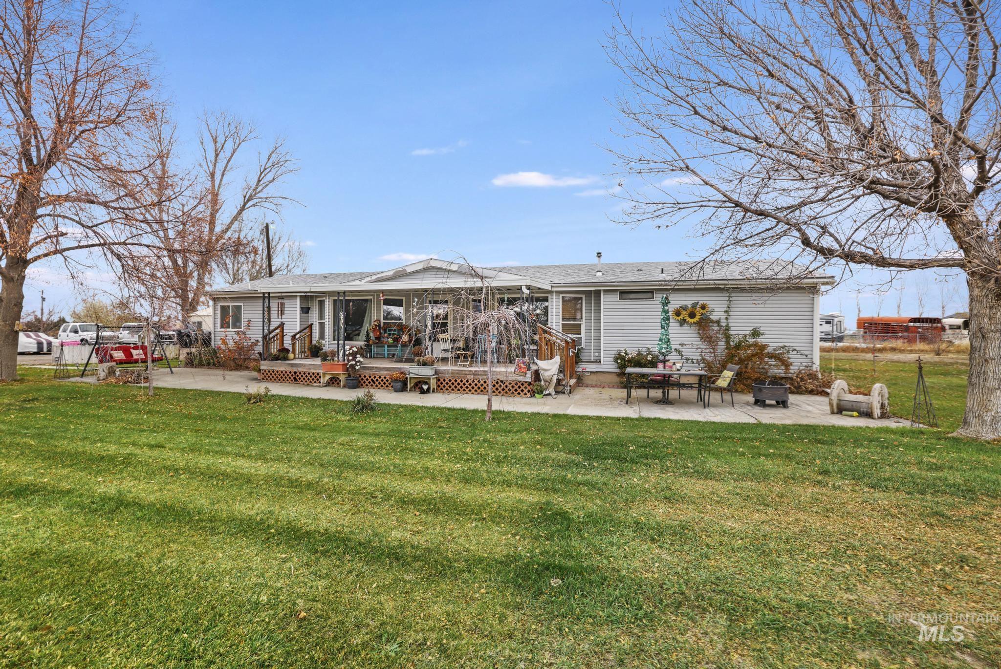 Front of Home featuring a patio and a wooden deck