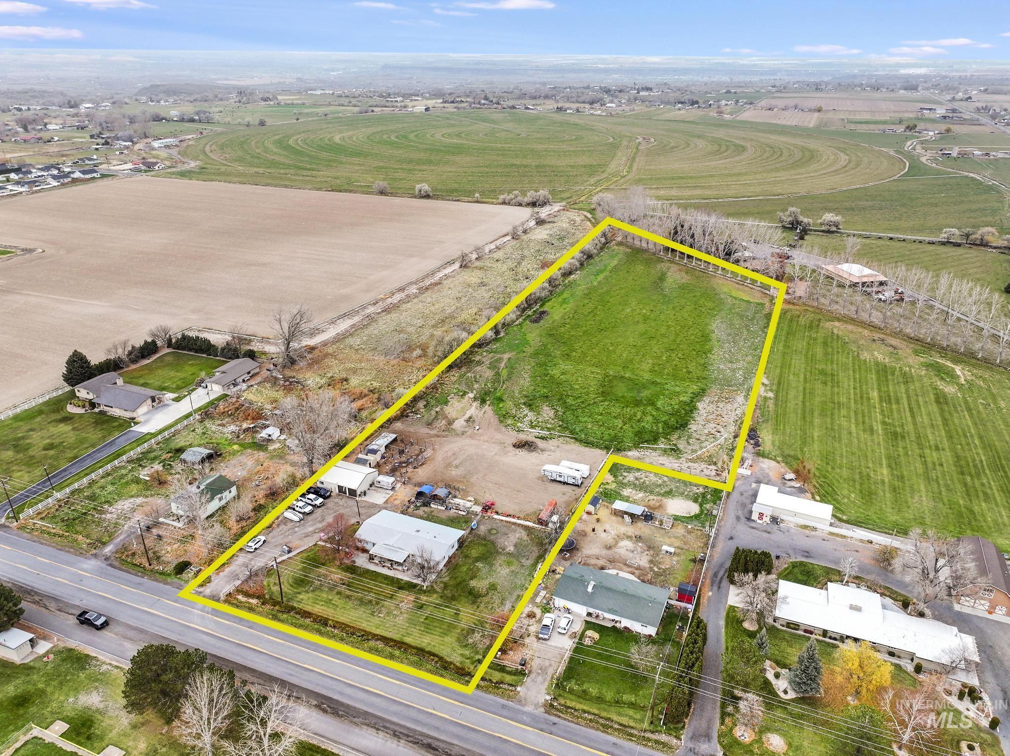 Aerial view of sparsely populated area with property parcel outlined