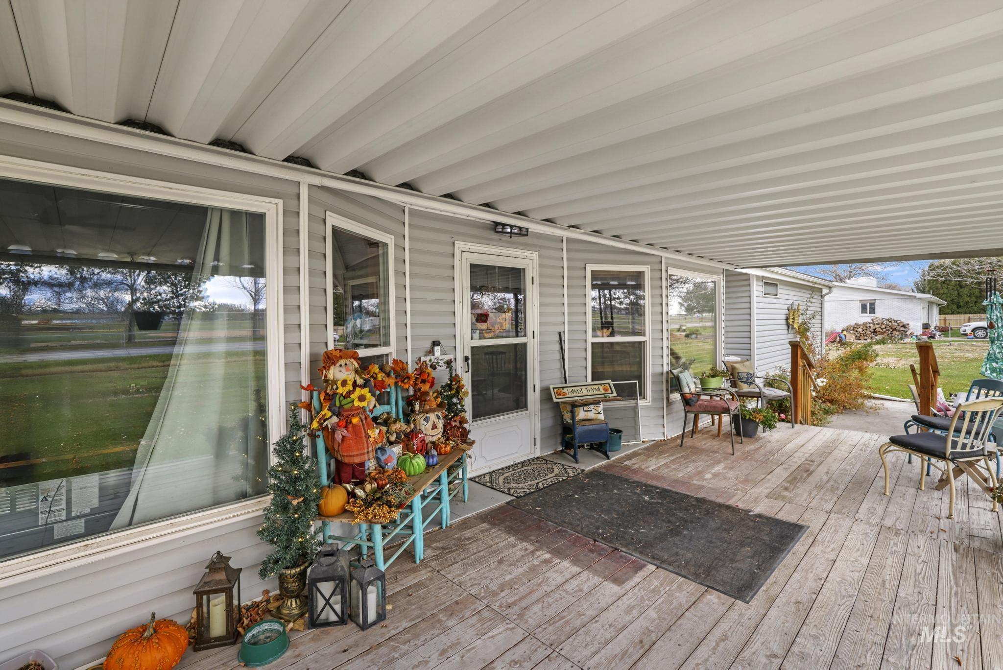 View of wooden terrace featuring front entry