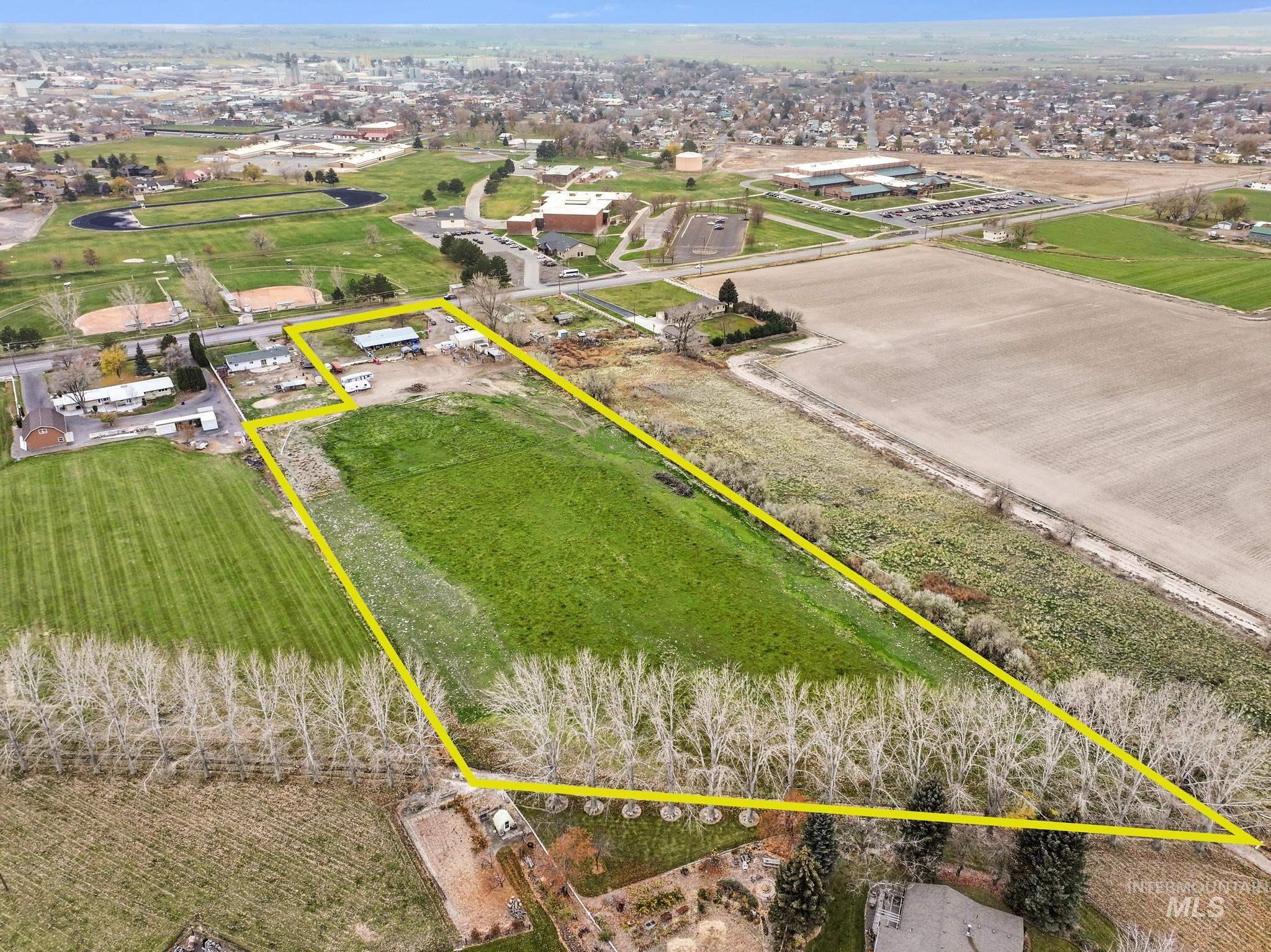 Aerial view of sparsely populated area featuring property boundaries highlighted and farmland