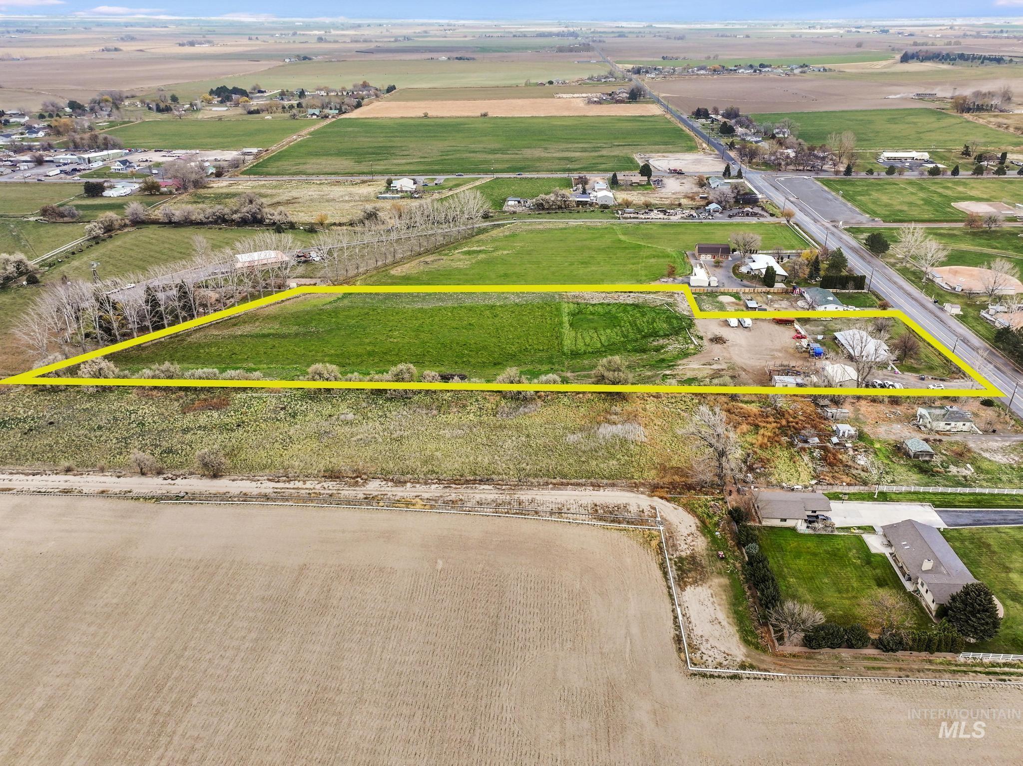 Aerial view of sparsely populated area featuring property parcel outlined