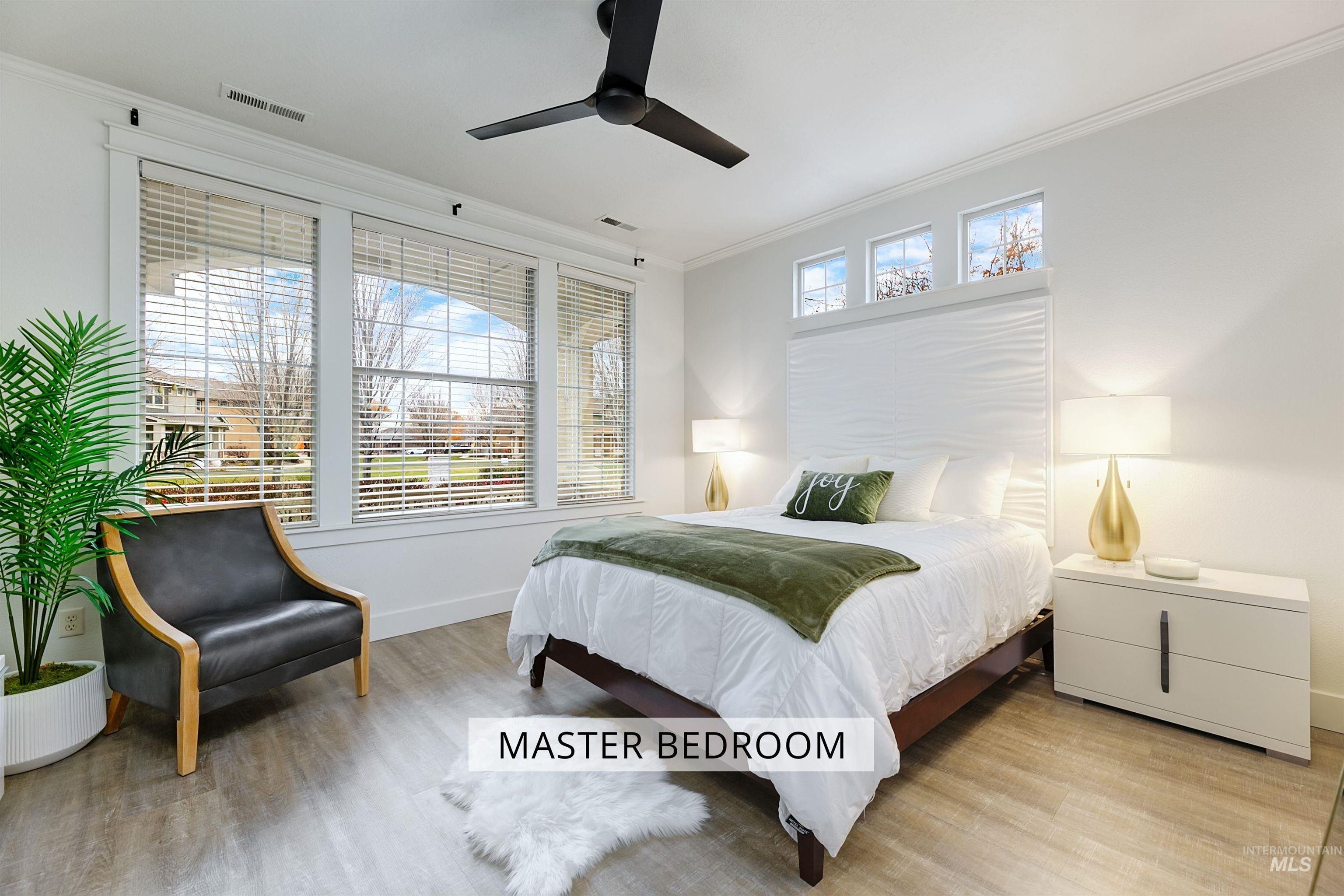 The master bedroom is bright and spacious, with large windows that offer plenty of natural light.
