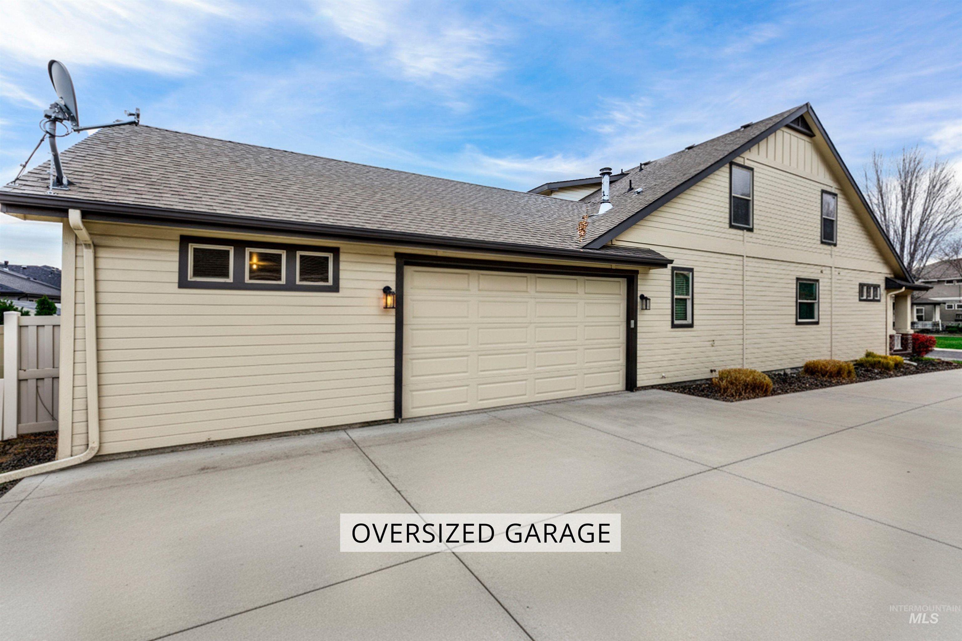 Long driveway connected to an oversized two car garage.