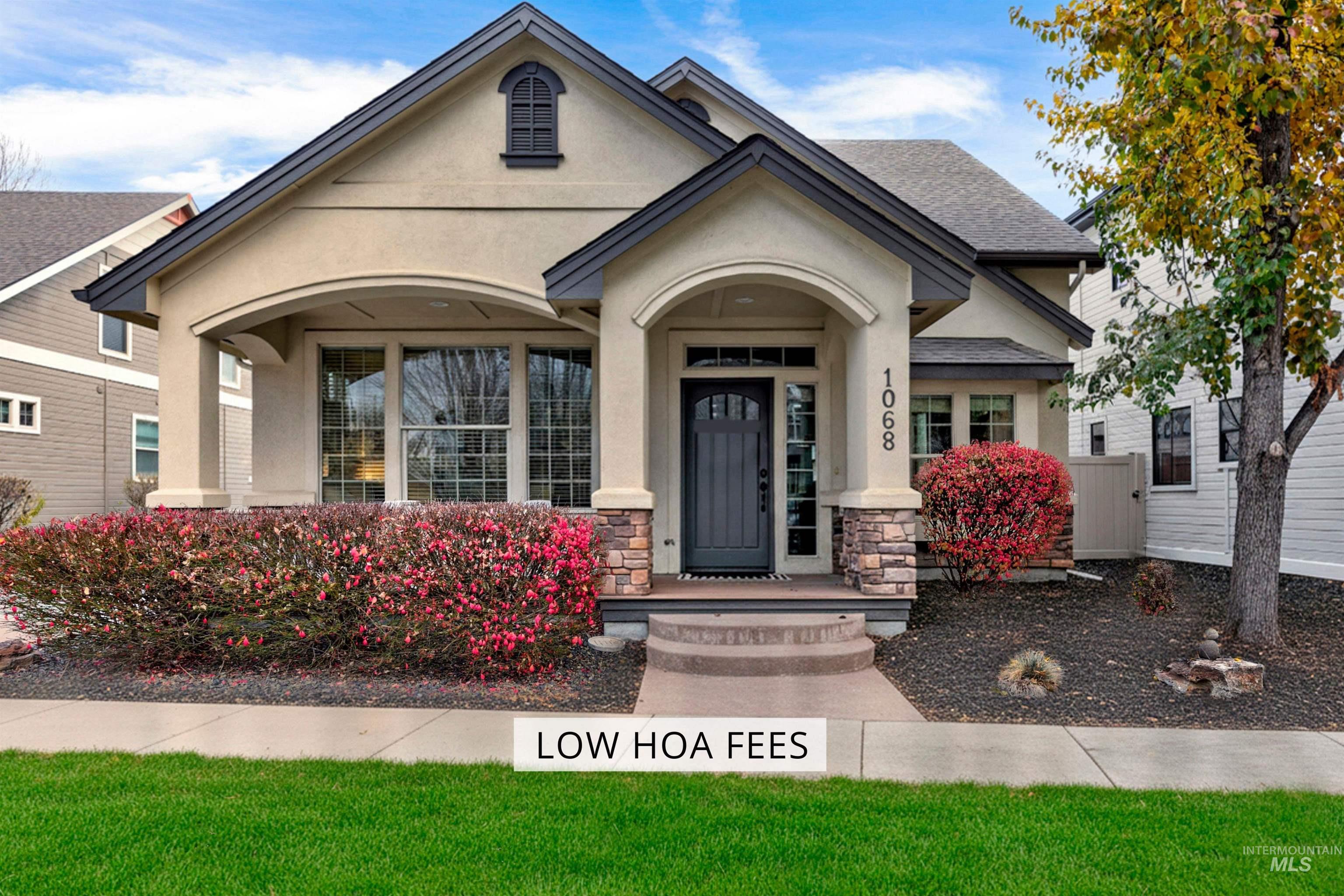 View of front of property with stucco siding, stone siding, and a porch