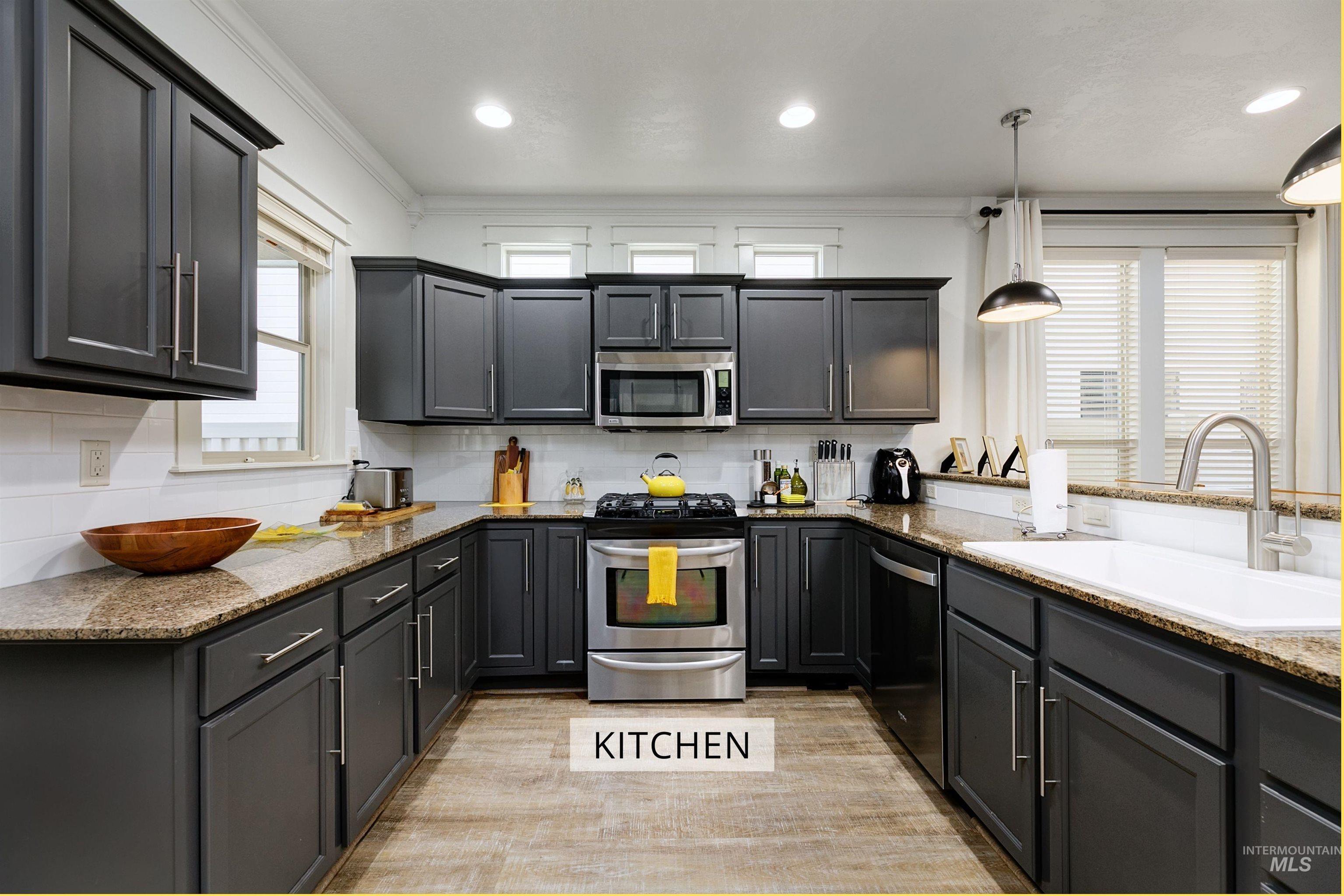 Spacious kitchen that features plenty of storage, stainless steel appliances, and ample counter space. Includes a dishwasher, range, microwave, and a garbage disposal.