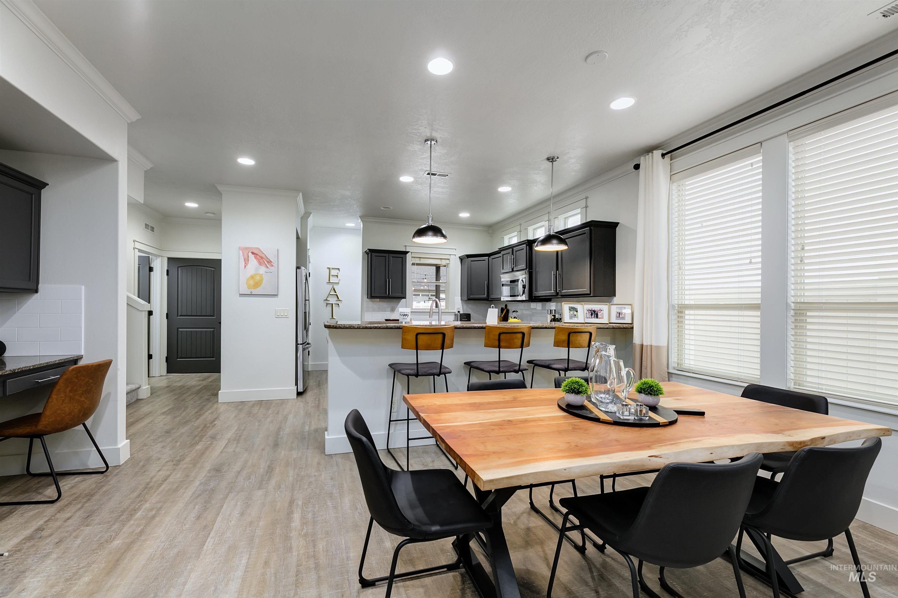 Dining space is bright and open, offering plenty of space. The seamless flow into the kitchen makes the area feel connected, functional, and welcoming.