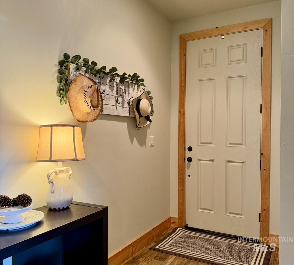 Entryway featuring baseboards and wood finished floors