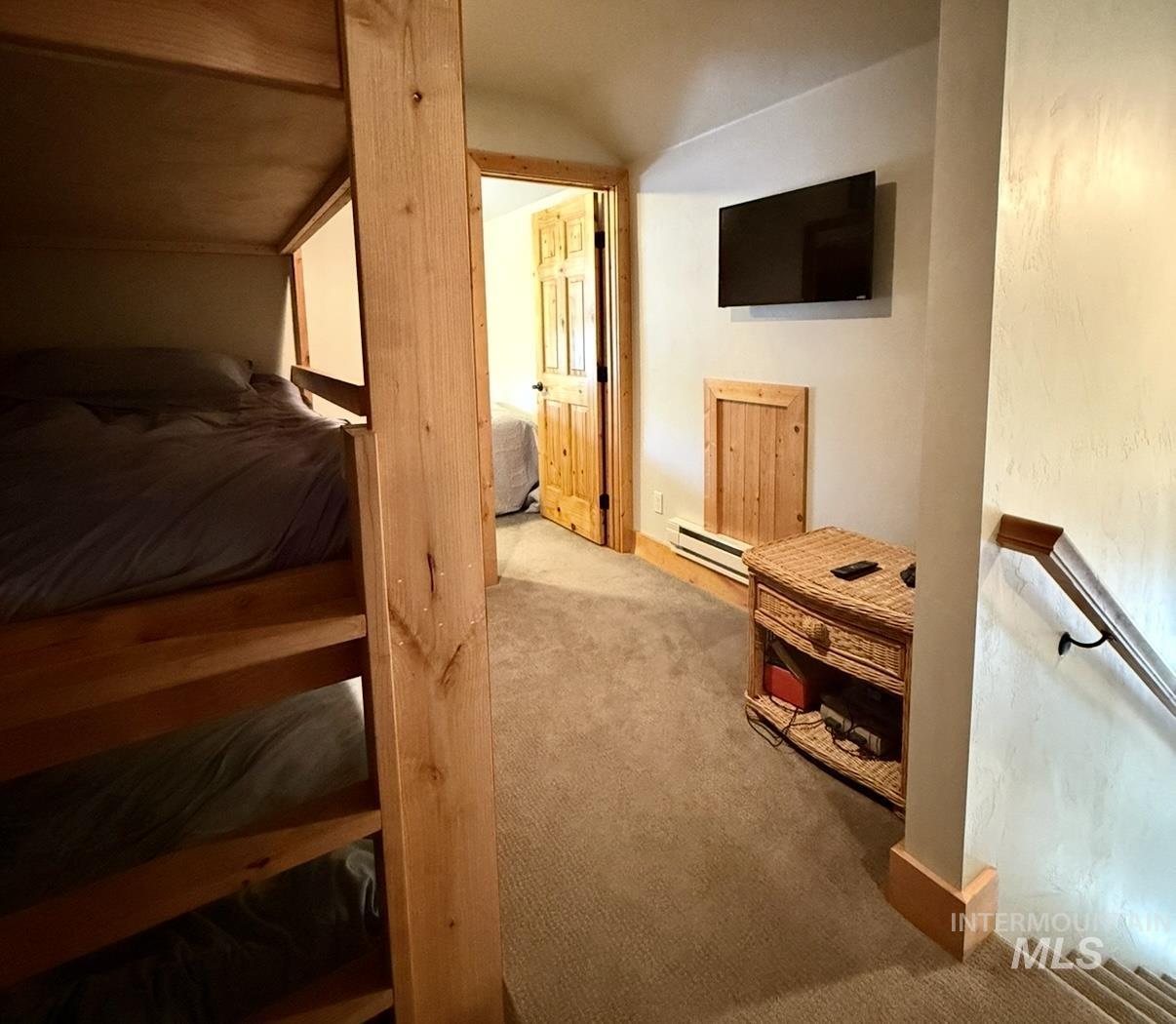 Bedroom featuring carpet floors and baseboard heating
