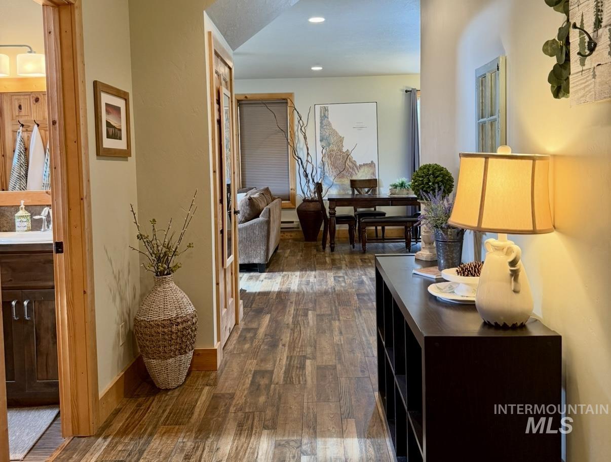 Hallway with dark wood finished floors and recessed lighting