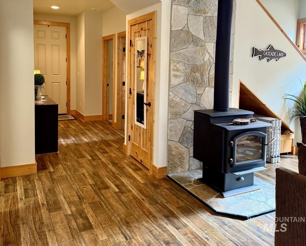 Hall with baseboards and dark wood-type flooring