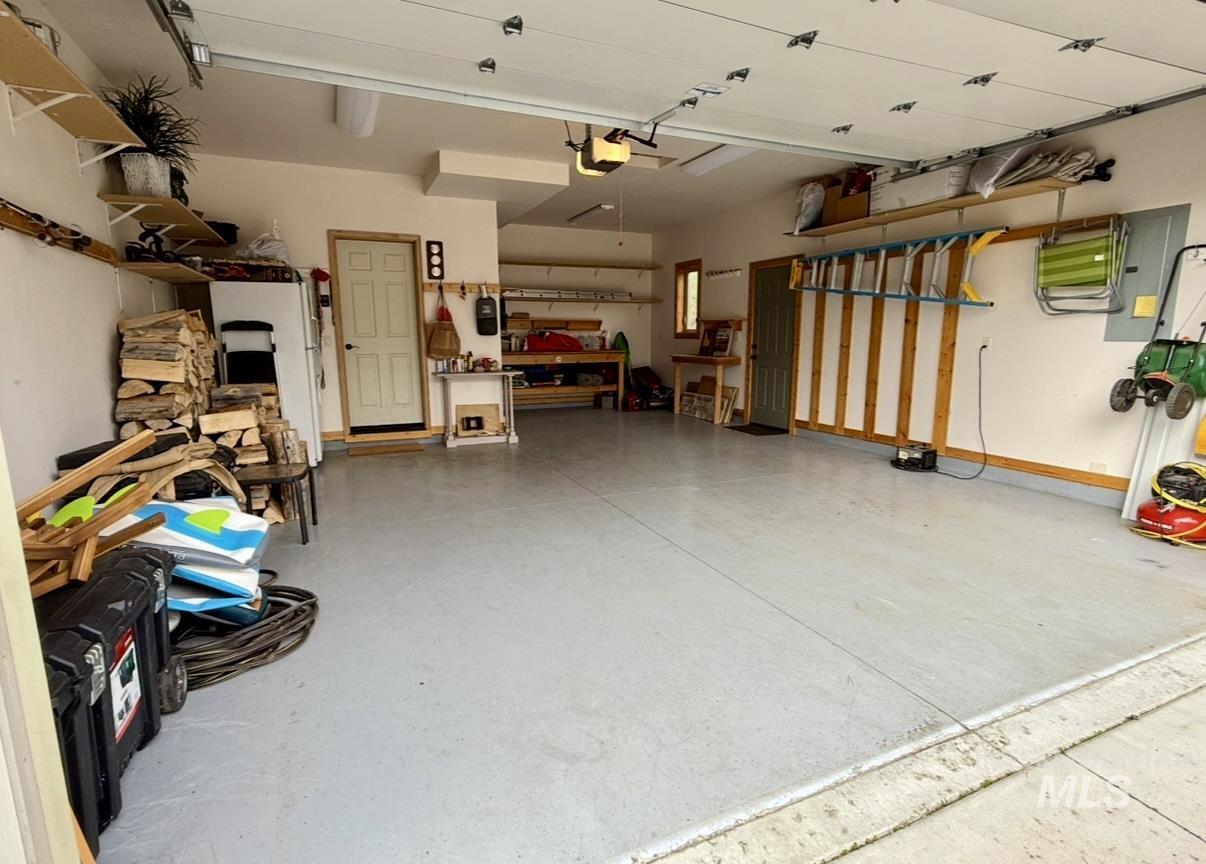Garage with electric panel and a garage door opener